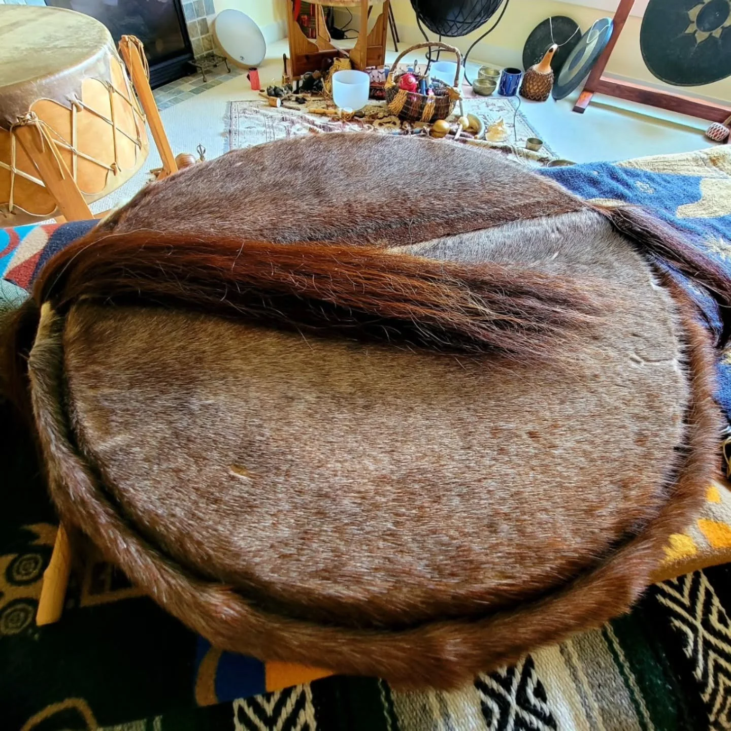 A shaman drum is traditionally a handheld frame drum, often made from natural materials like animal hide stretched over a wooden hoop - used in spiritual practices for healing, meditation and achieving altered states of consciousness to connect with 
