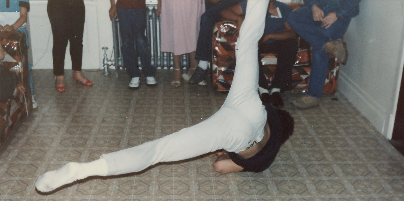 Bboy London practicing a power move in his grandma's apartment, 1983. Courtesy of Bboy London.