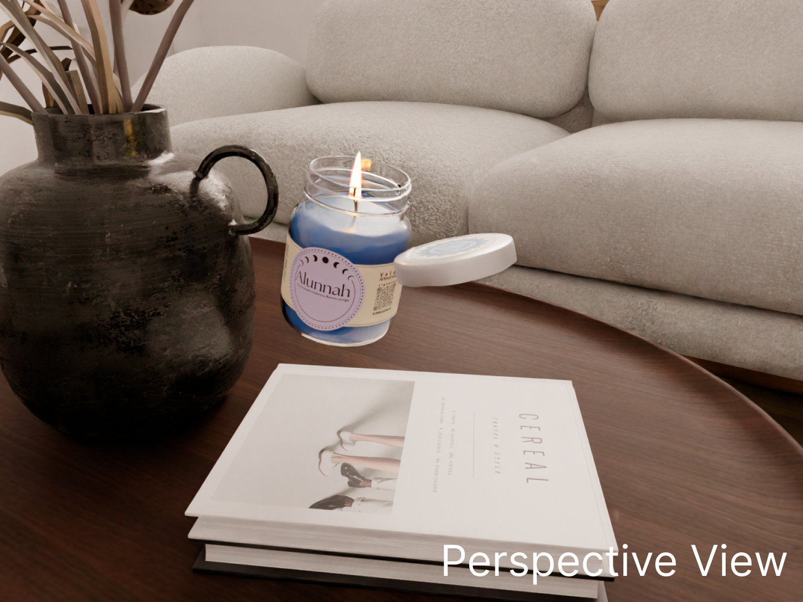 A black rustic vase with brown sticks on a wooden coffee table, a lit blue candle in a jar labeled 'Alunnah', a closed white round container, and a magazine titled 'Eternal' with a minimalist cover design in front of a beige sofa.