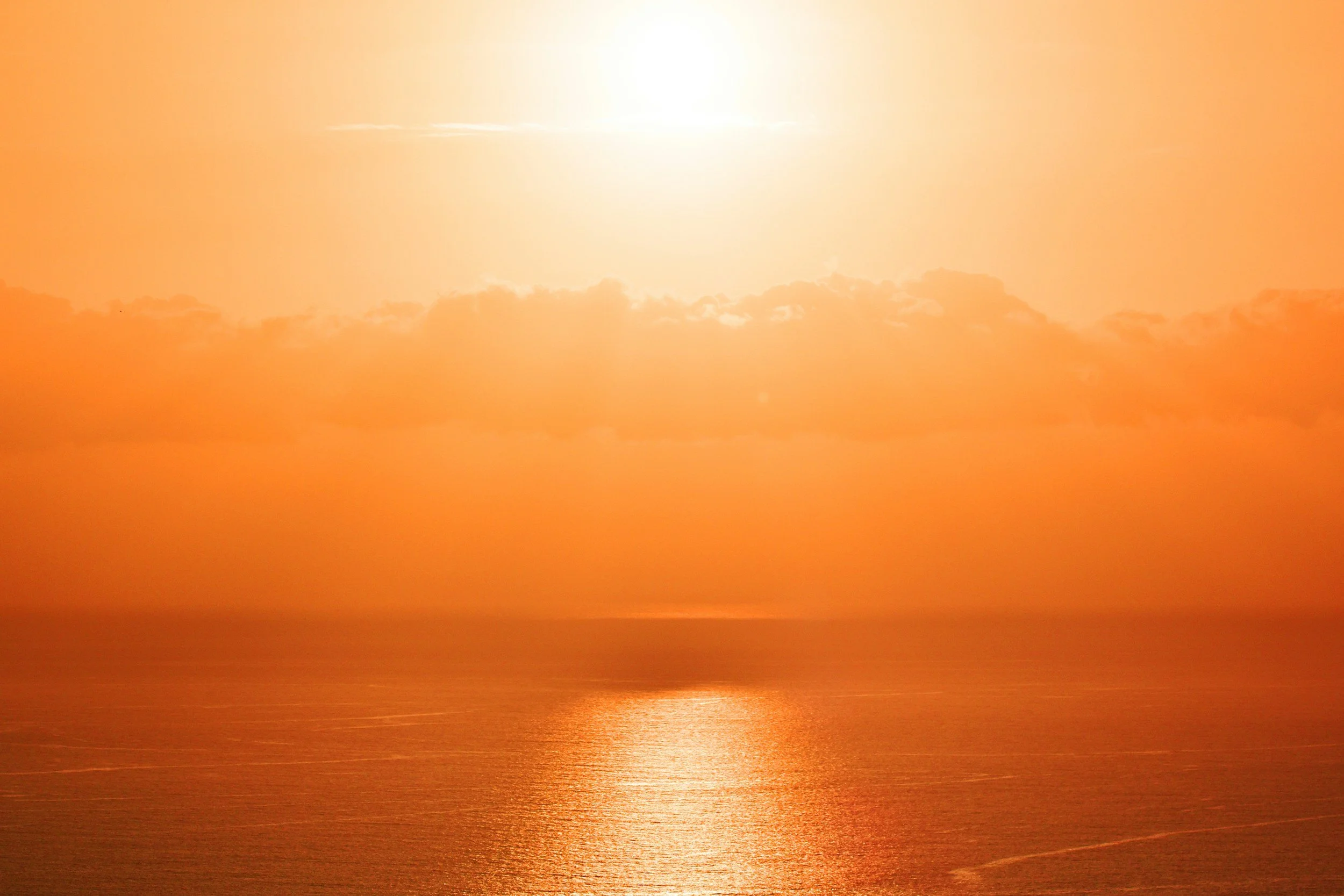 Golden sunset over a calm ocean horizon, evoking hope and the promise of a more sustainable future