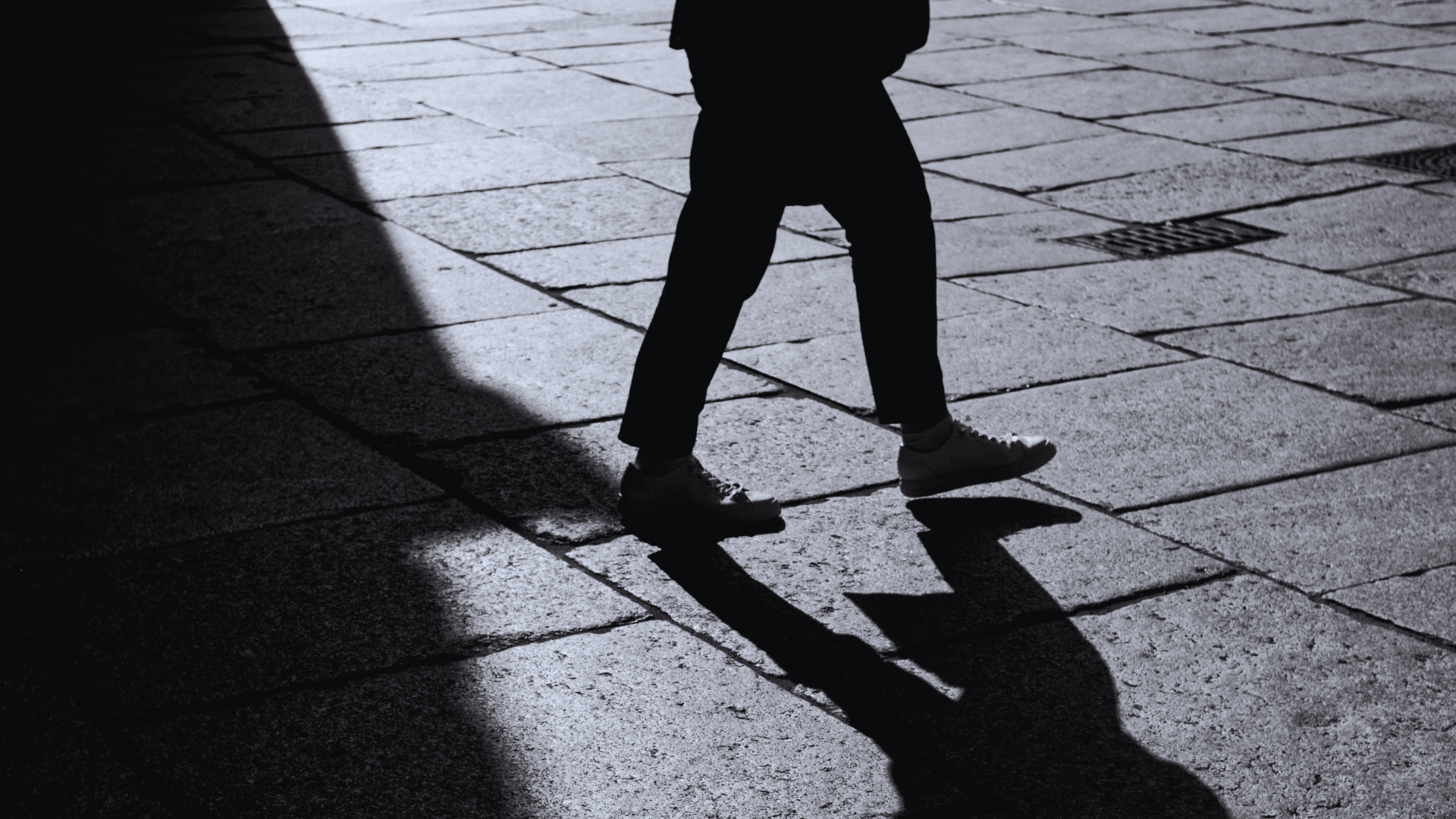 Person stepping from darkness into light symbolizing personal transformation and life transition