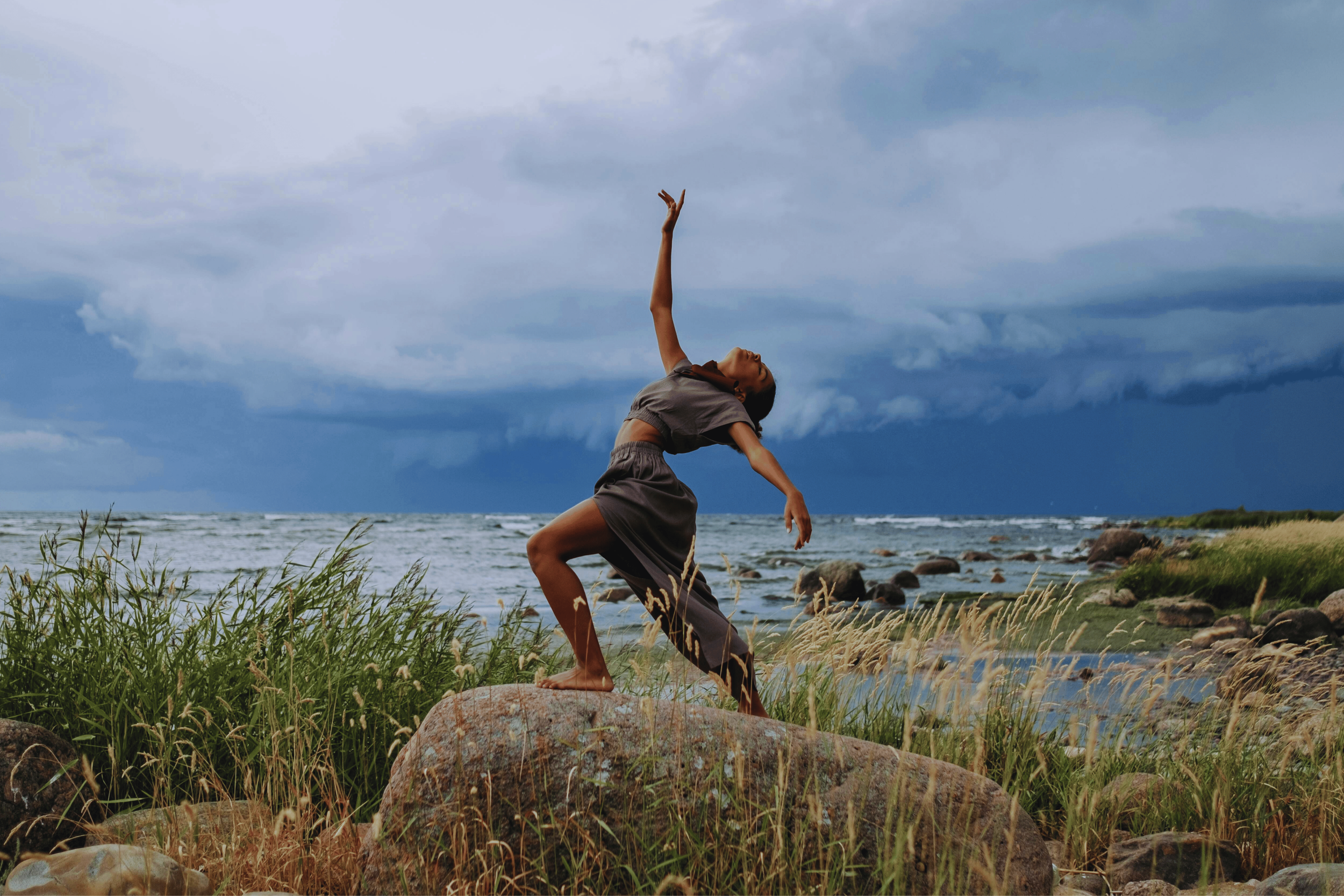 Person moving freely in nature symbolizing embodied pleasure, connection, and aliveness.