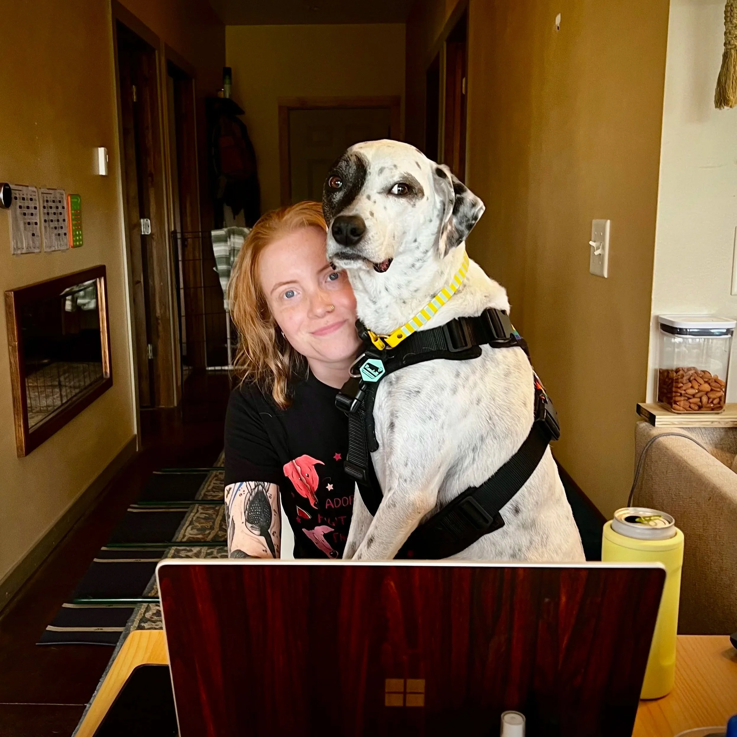 Randall sits on Lily's lap at a table and looks awkwardly at the camera