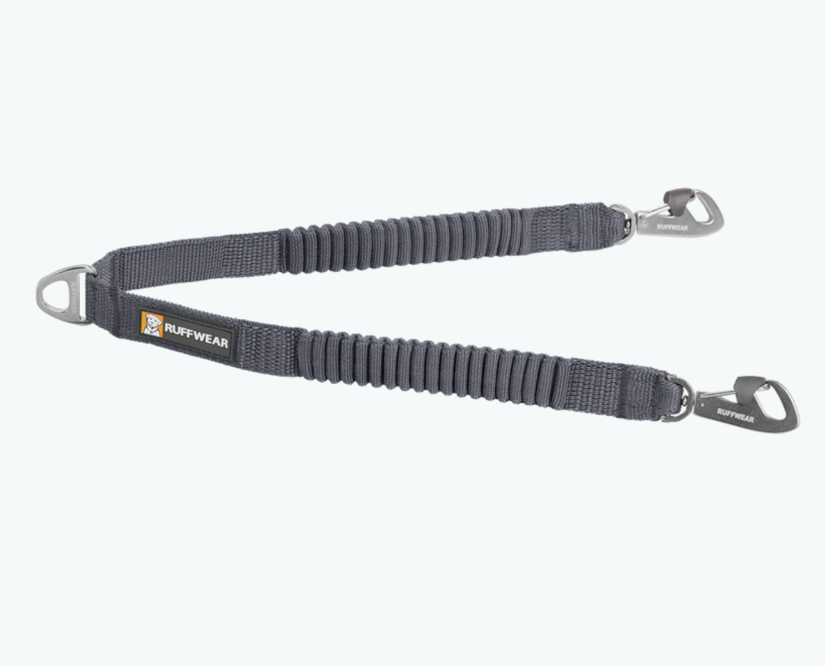DOUBLE TRACK LEASH COUPLER from RUFFWEAR. To add a more secure attachment from leash to harness with less sudden impacts, clip this to the front & rear of your dog's harness. NOT recommended as a leash coupler for two dogs (I don't recommend using le