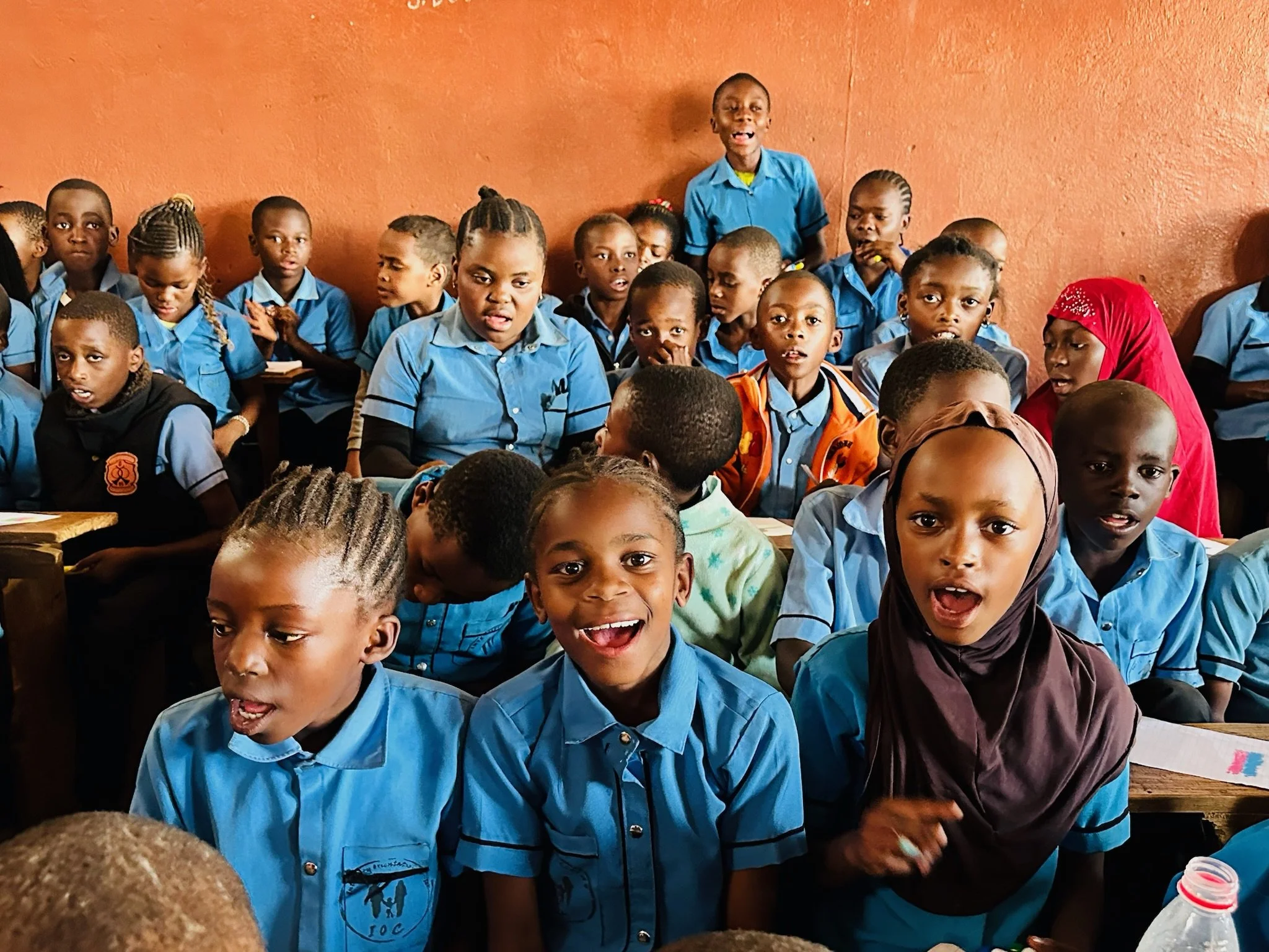 kids in a classroom in malawi smiling