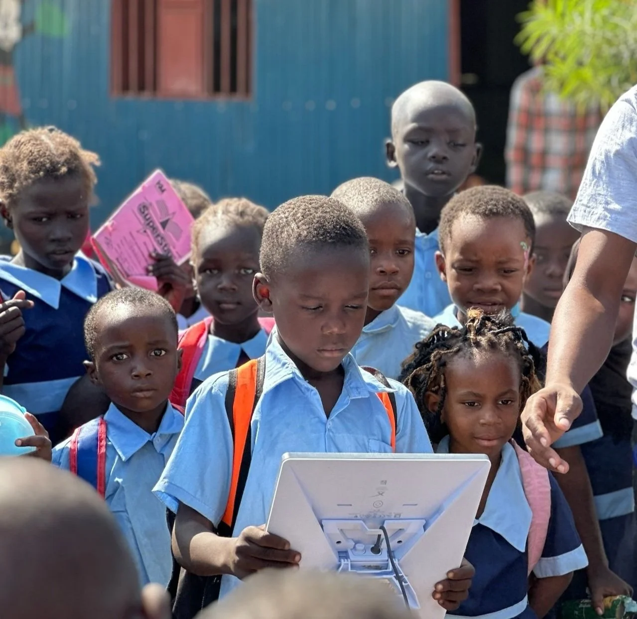 image of a young kenyan boy holding a starlink terminal