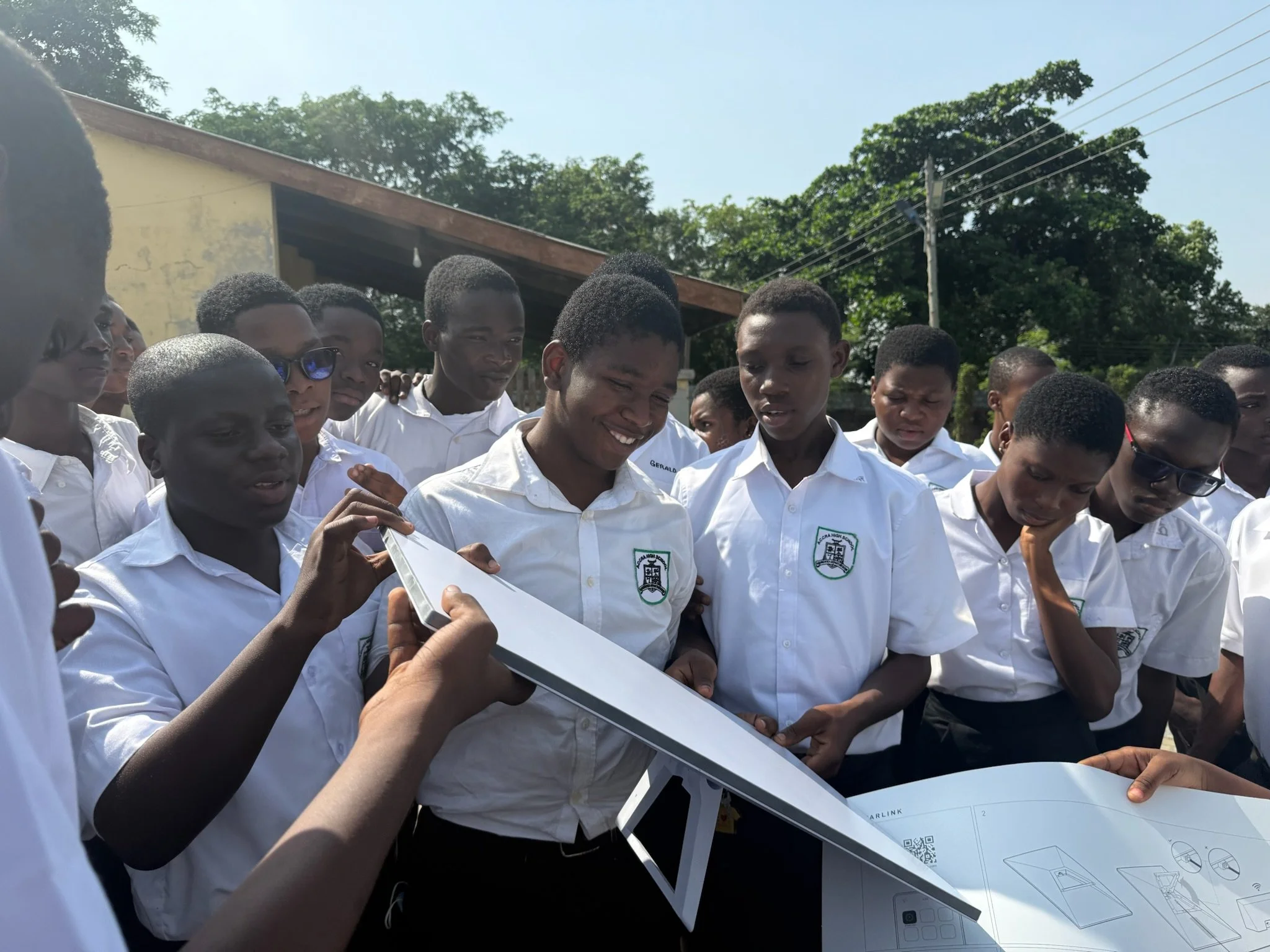 image of a group of young African boys holding up a starlink