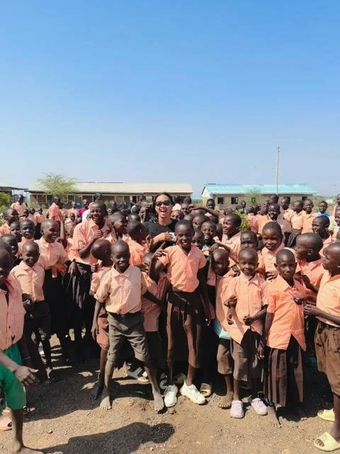 image of a man standing in a group of school kids in africa