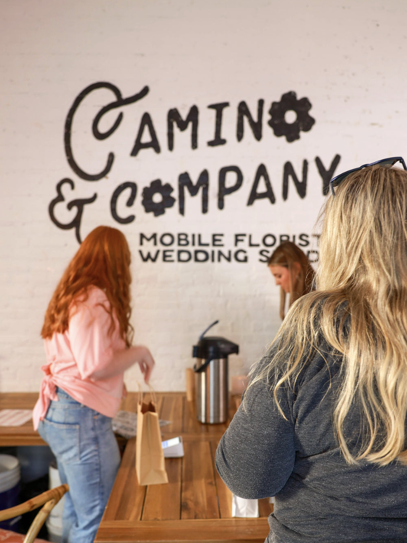 Wedding florist branding for Camino & Company featuring storefront logo signage reading “Mobile Florist Wedding” in a modern, hand-lettered style. Example of boutique floral brand and website design for creative entrepreneurs.