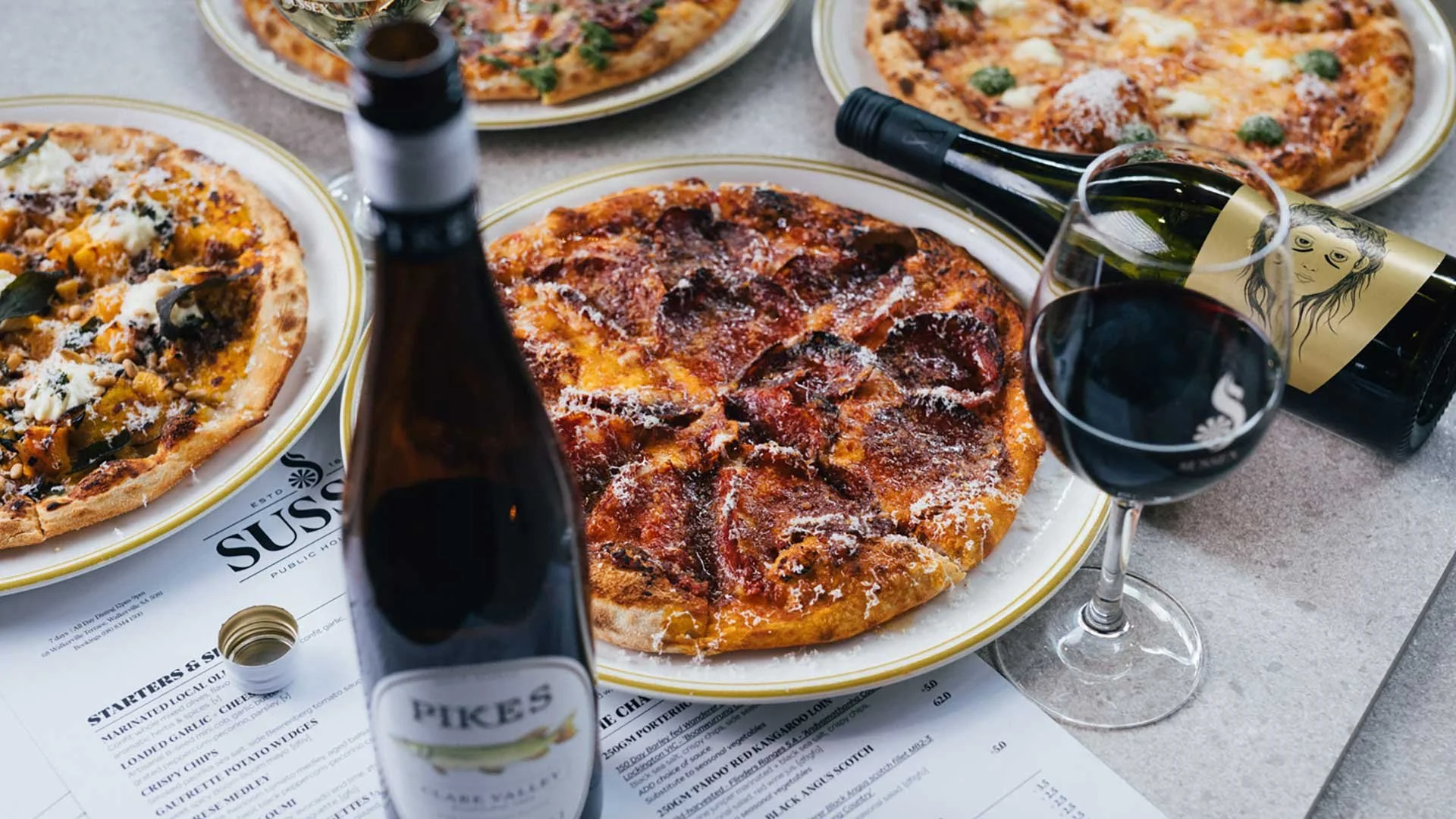 Pizza and wine special with two 12-inch pizzas and glasses of wine at Sussex Hotel Walkerville Wednesday deal