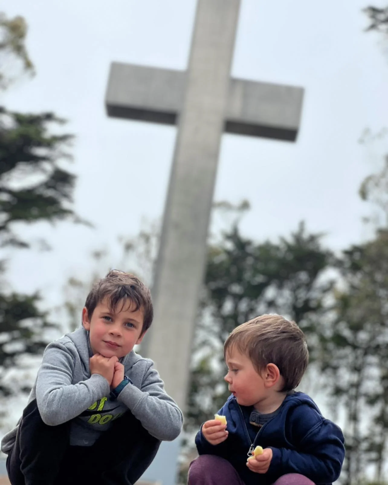 Two adorable kids visiting our iconic cross.