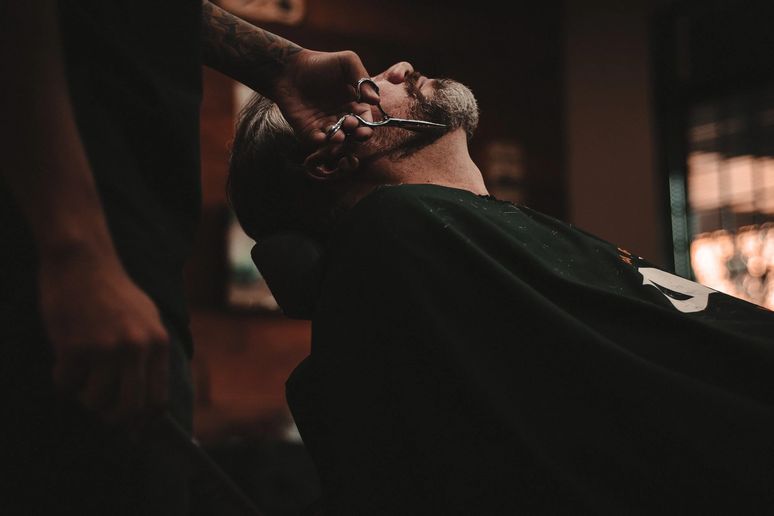 man getting a trim on his beard