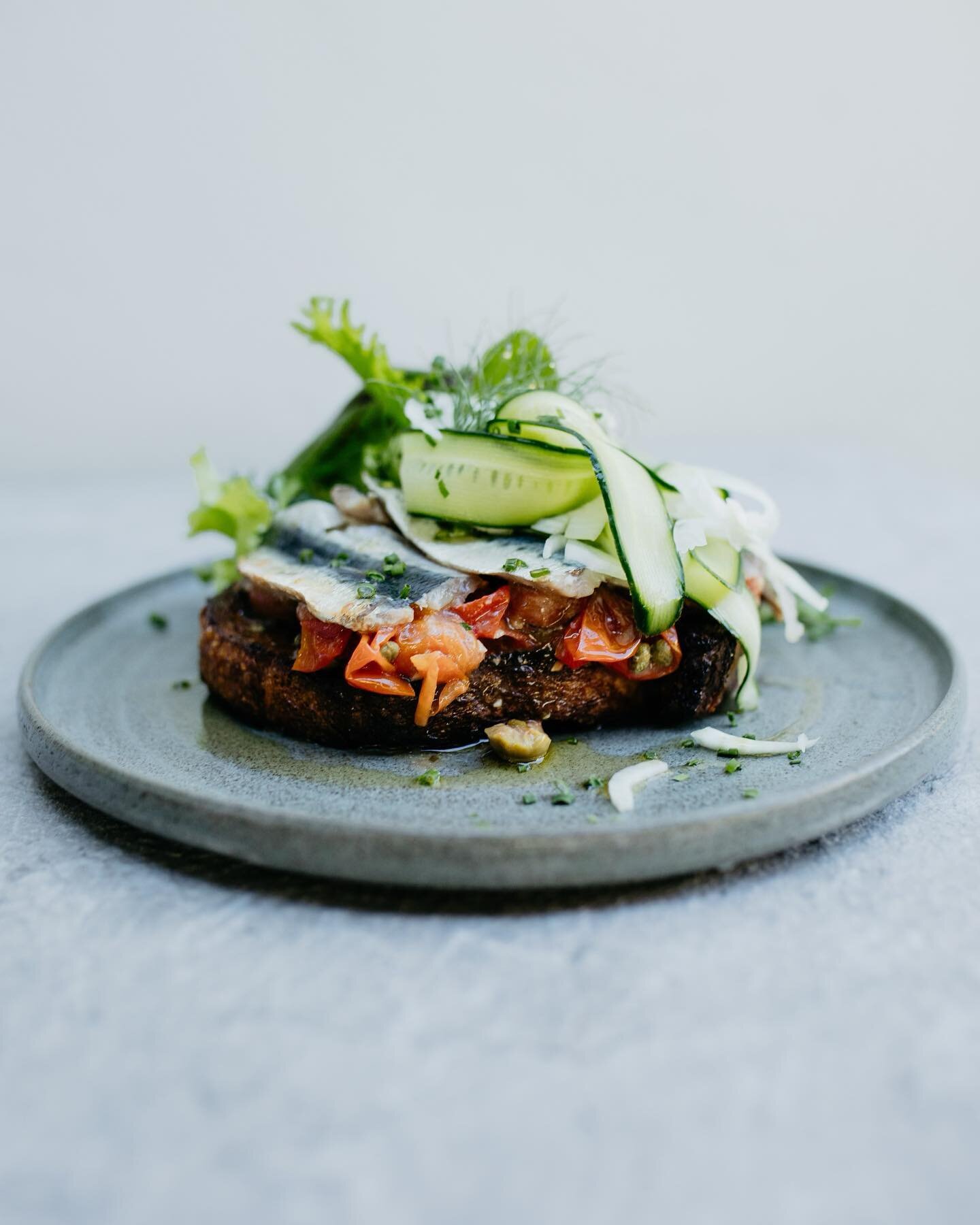 Nothing beats fresh sardines and our take on this autumn dish is described as next level. Sardines | oven roasted fresh sardine fillets + blistered vine tomatoes + capers + green olives + shaved fennel cucumber salad + kraken sourdough (GFO). Paired 