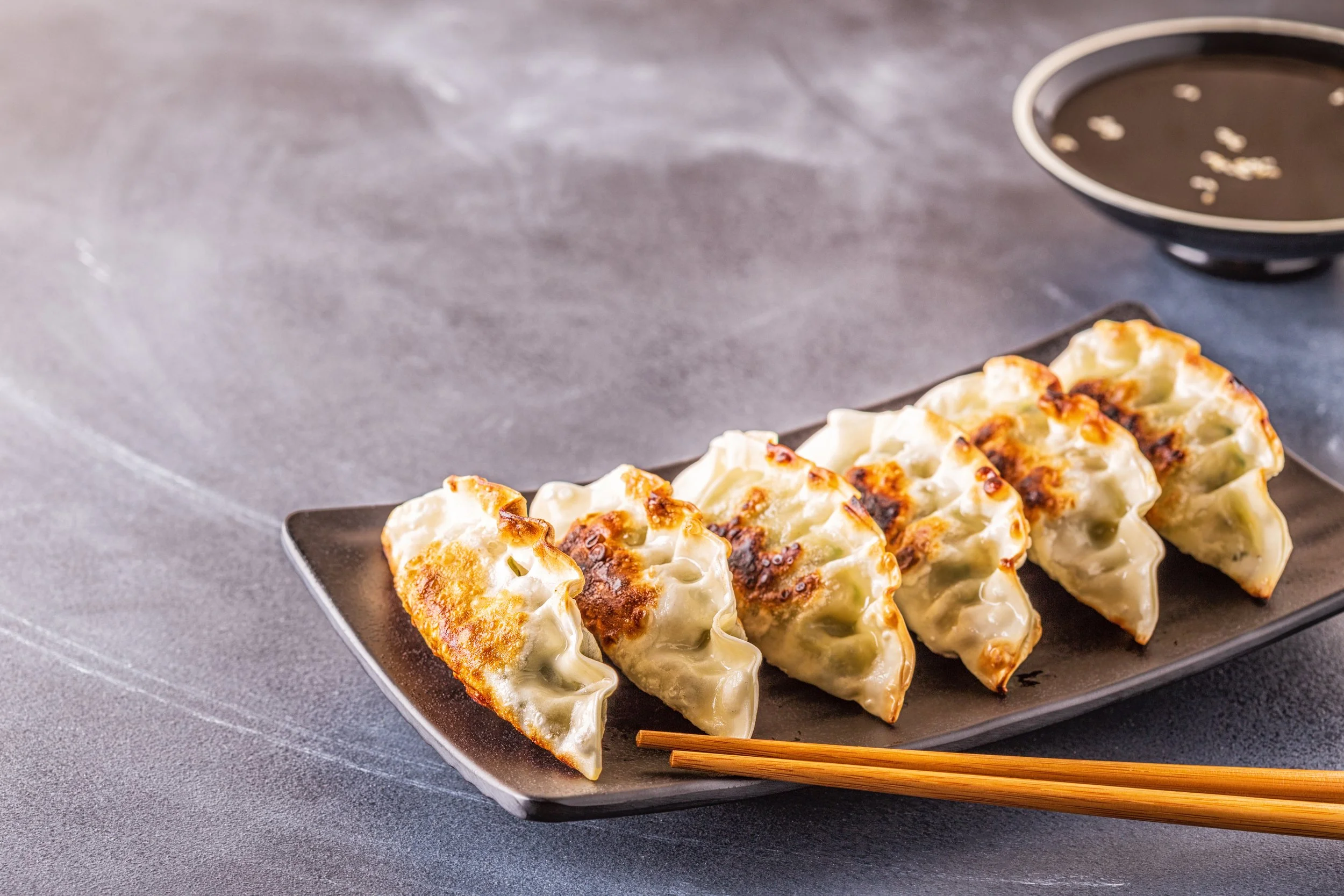 Gyoza (chicken & vegetable dumplings) with dipping sauces