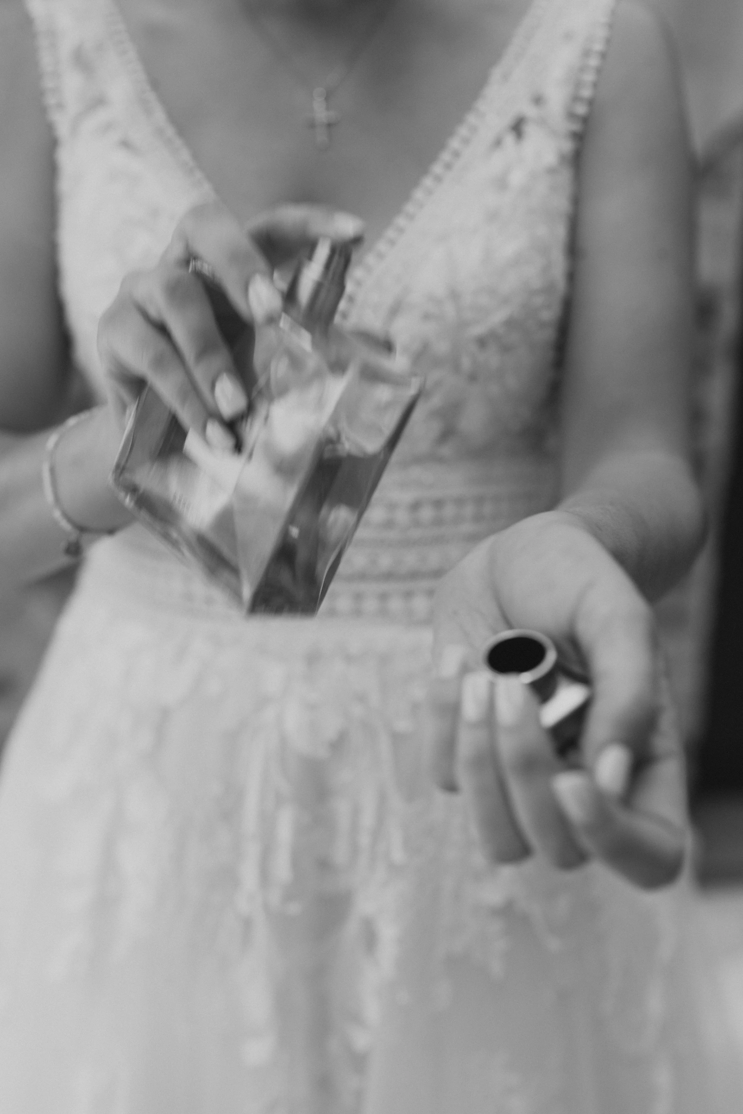 Mano sosteniendo un paquete de leche y una lata de leche condensada, vestido con blusa blanca de encaje.