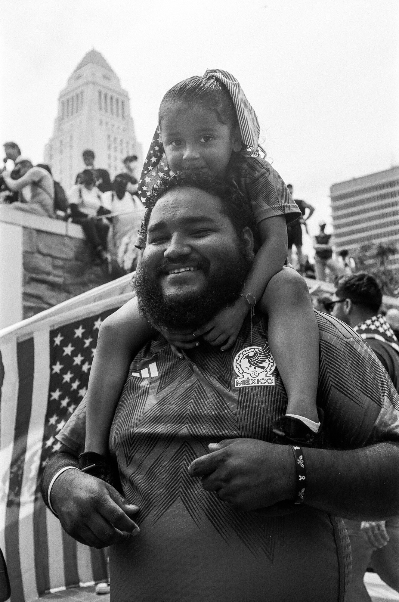A father and daughter protest outside the Federal Building in downtown Los Angeles during the No Kings Protest, June 14, 2025.