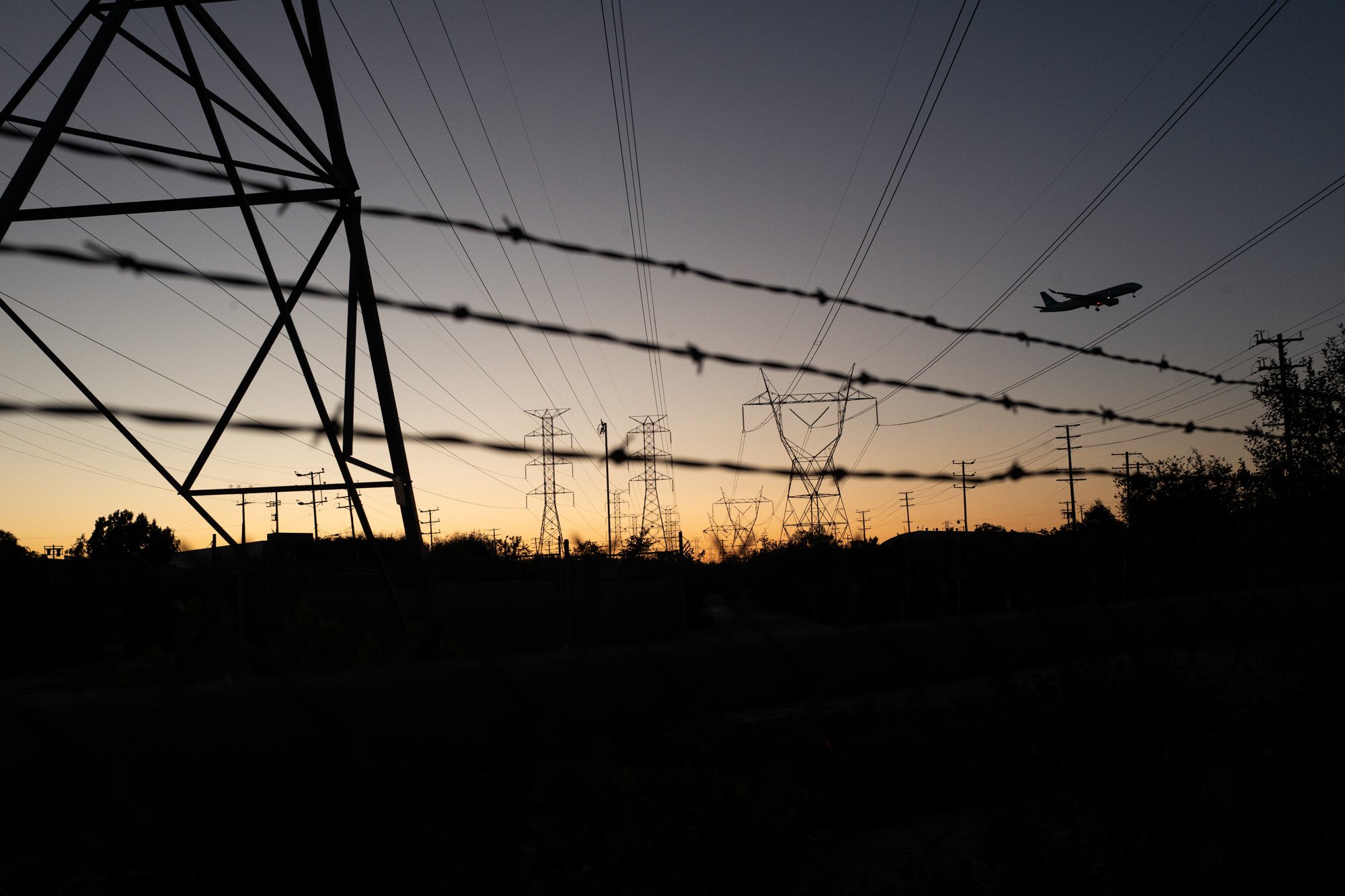Sun sets over an industrial area of the San Fernando Valley, July 6, 2025.