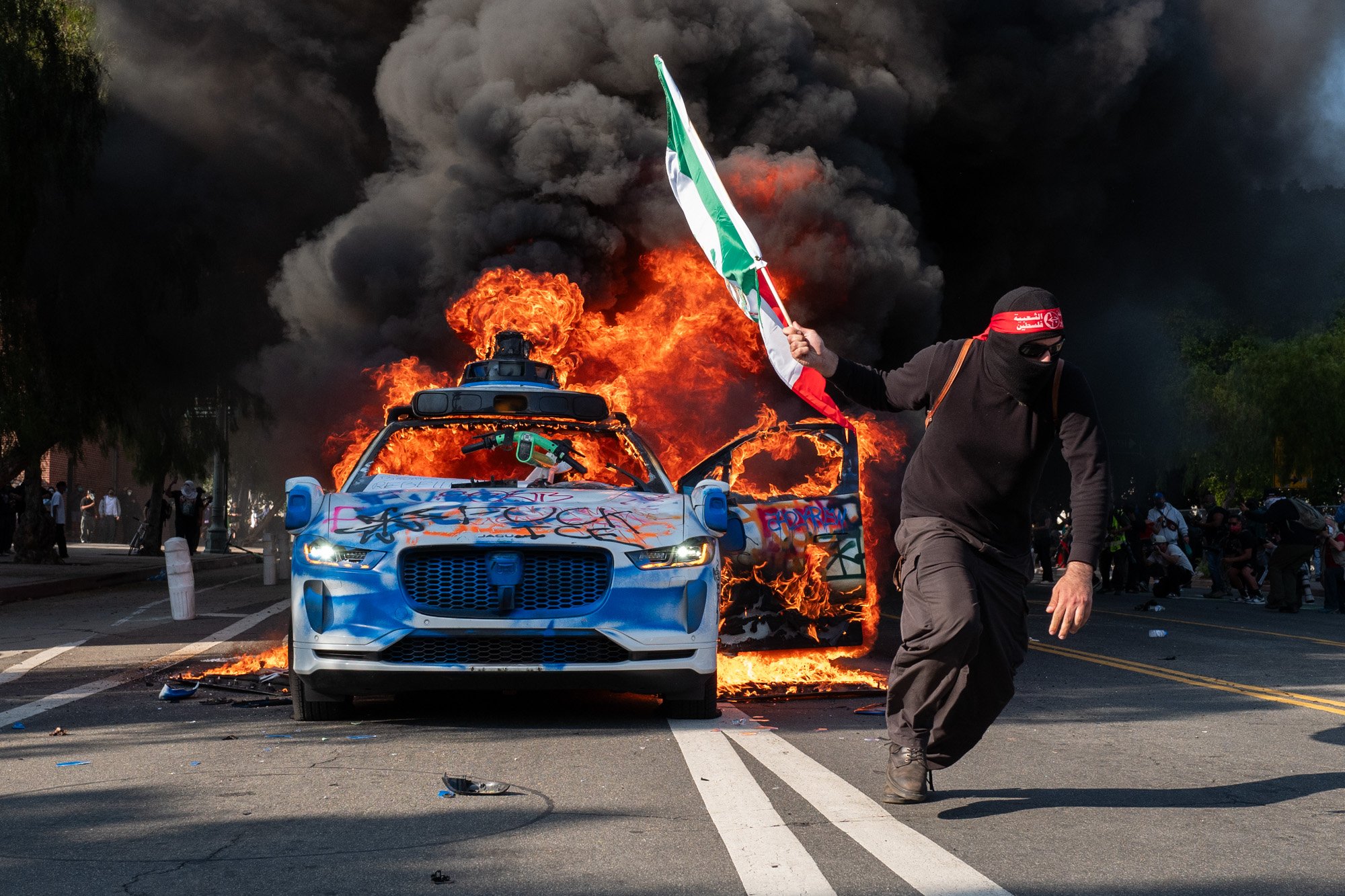 A Waymo car burns during an anti-ICE protest. Los Angeles, CA, USA (6/8/25)