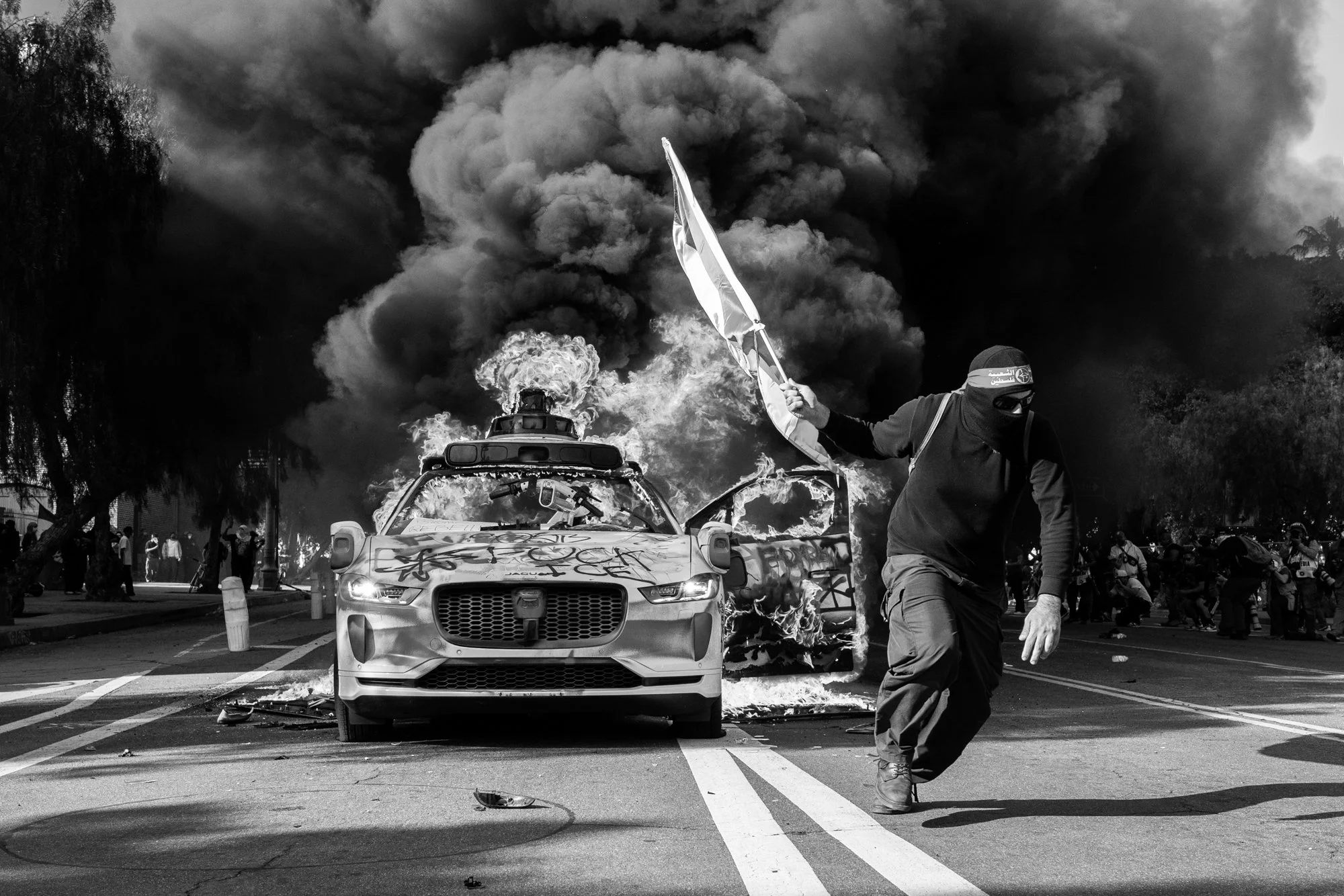  A Waymo car burns during an anti-ICE protest.  Los Angeles, CA, USA (6/8/25) 