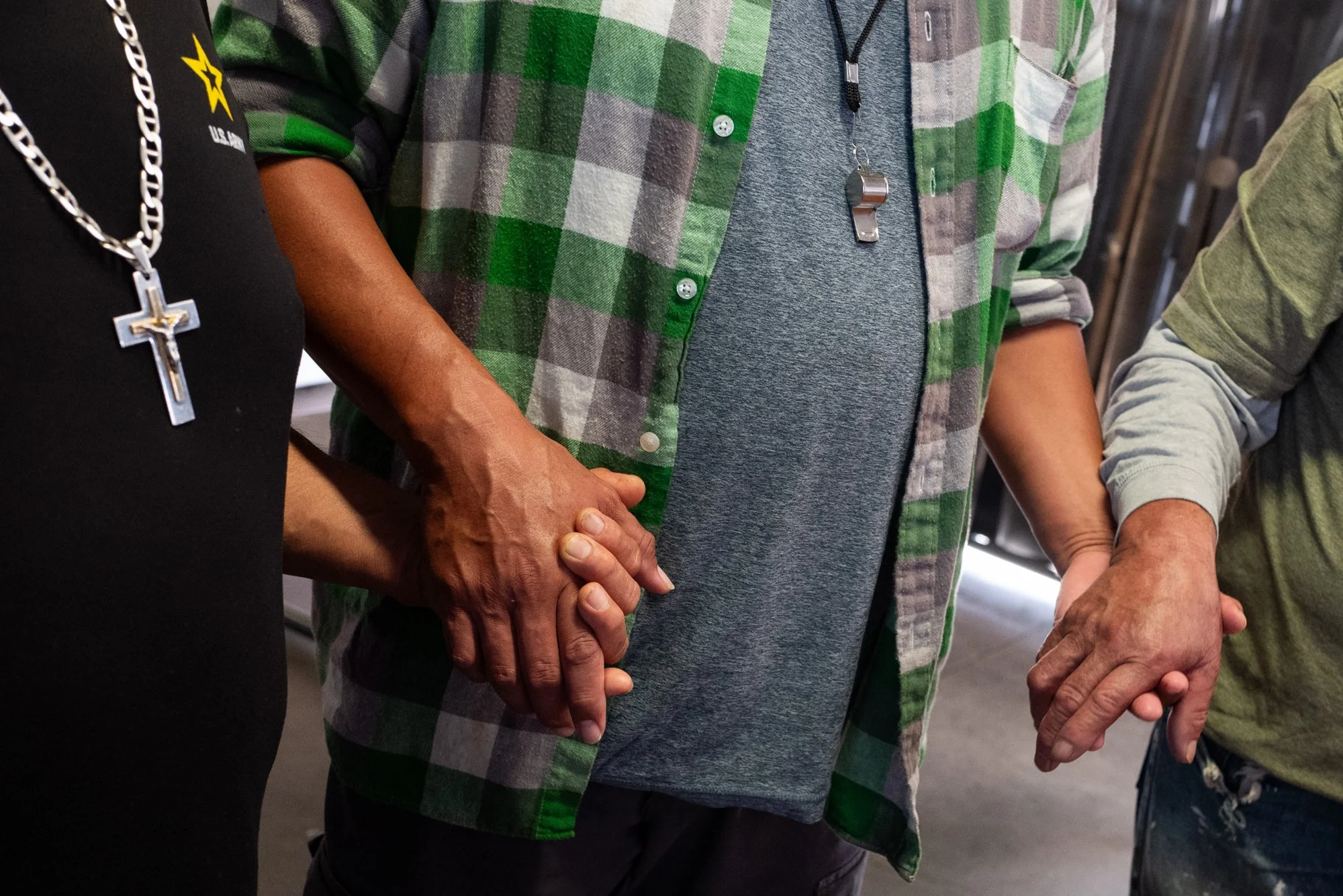  Day laborers hold hands in a circle while sharing their experiencing during a “convivio” at the Day Laborers Community Job Center at the Van Nuys Home Depot.  Los Angeles, CA, USA (11/1/25) 