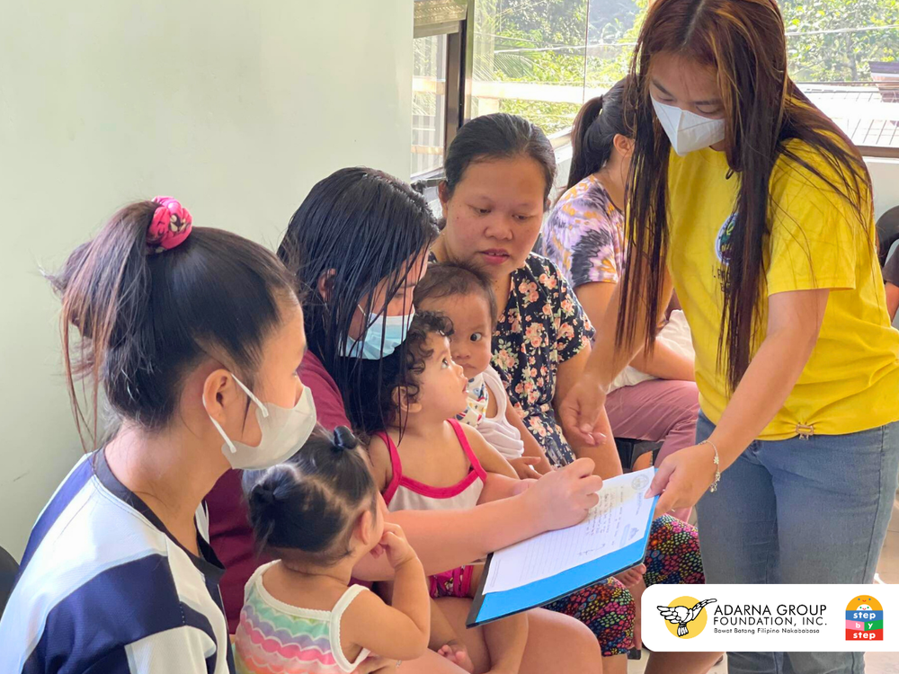  Mothers and their children receive learning materials during their scheduled health check-ups. During these brief in-person visits, new parents have the opportunity to ask questions, receive valuable insight from health workers, and learn from their