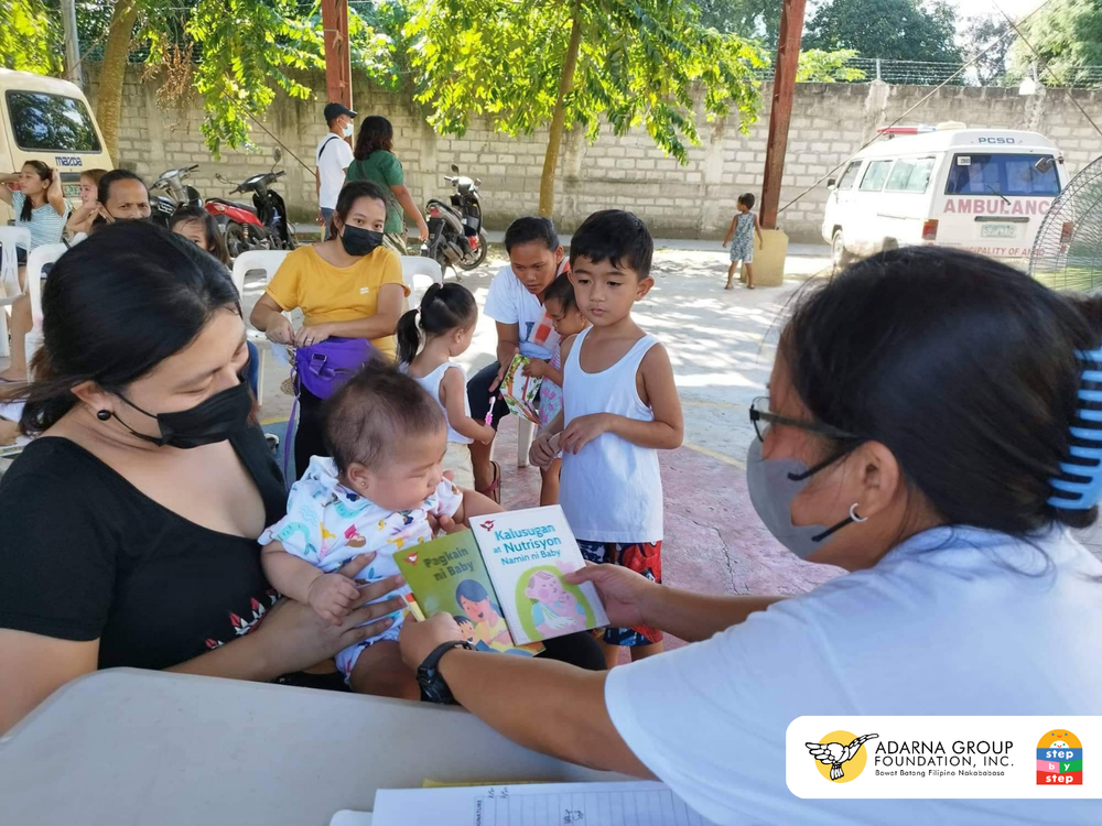  Mothers and their children receive learning materials during their scheduled health check-ups. During these brief in-person visits, new parents have the opportunity to ask questions, receive valuable insight from health workers, and learn from their