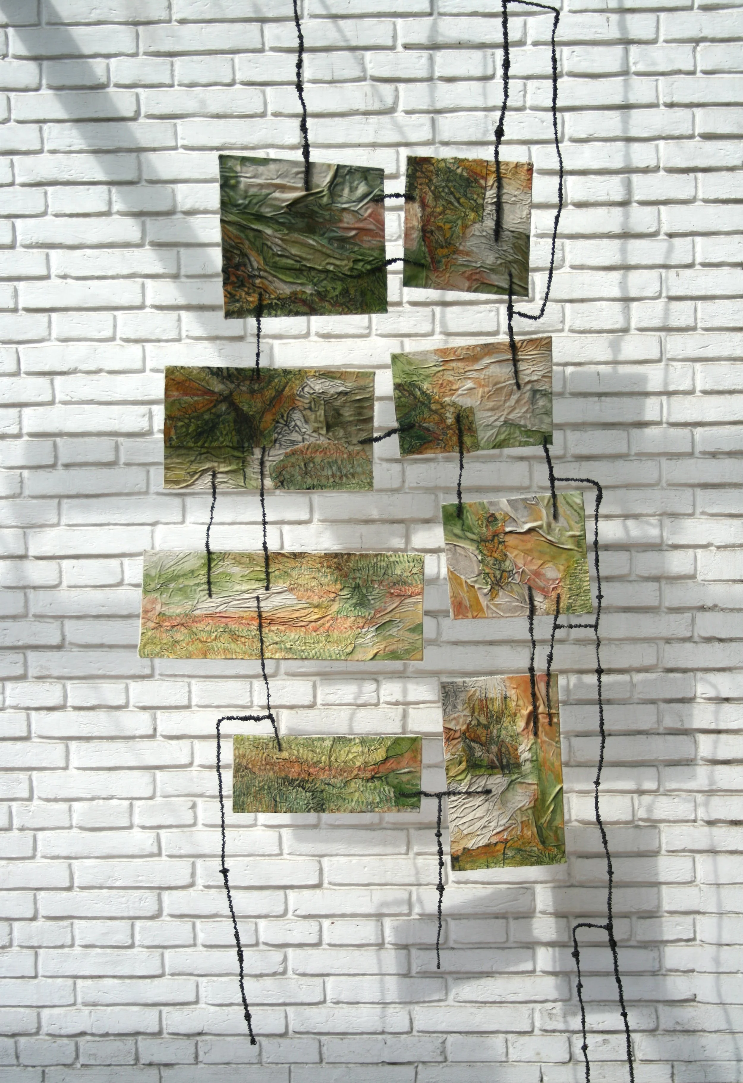 “Moments Go Memories Remain …..”,
Pen & Ink, Acrylic, paper, fabric & wire.
30” x 92”, 2011 