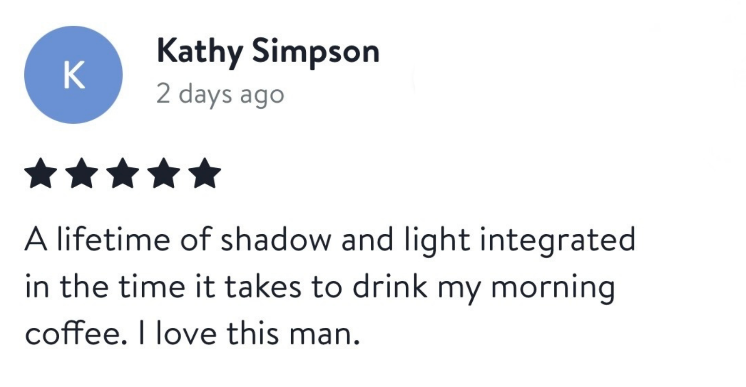 Screenshot of a Google review for a man named Kathy Simpson, who gave a five-star rating. The review says, "A lifetime of shadow and light integrated in the time it takes to drink my morning coffee. I love this man."