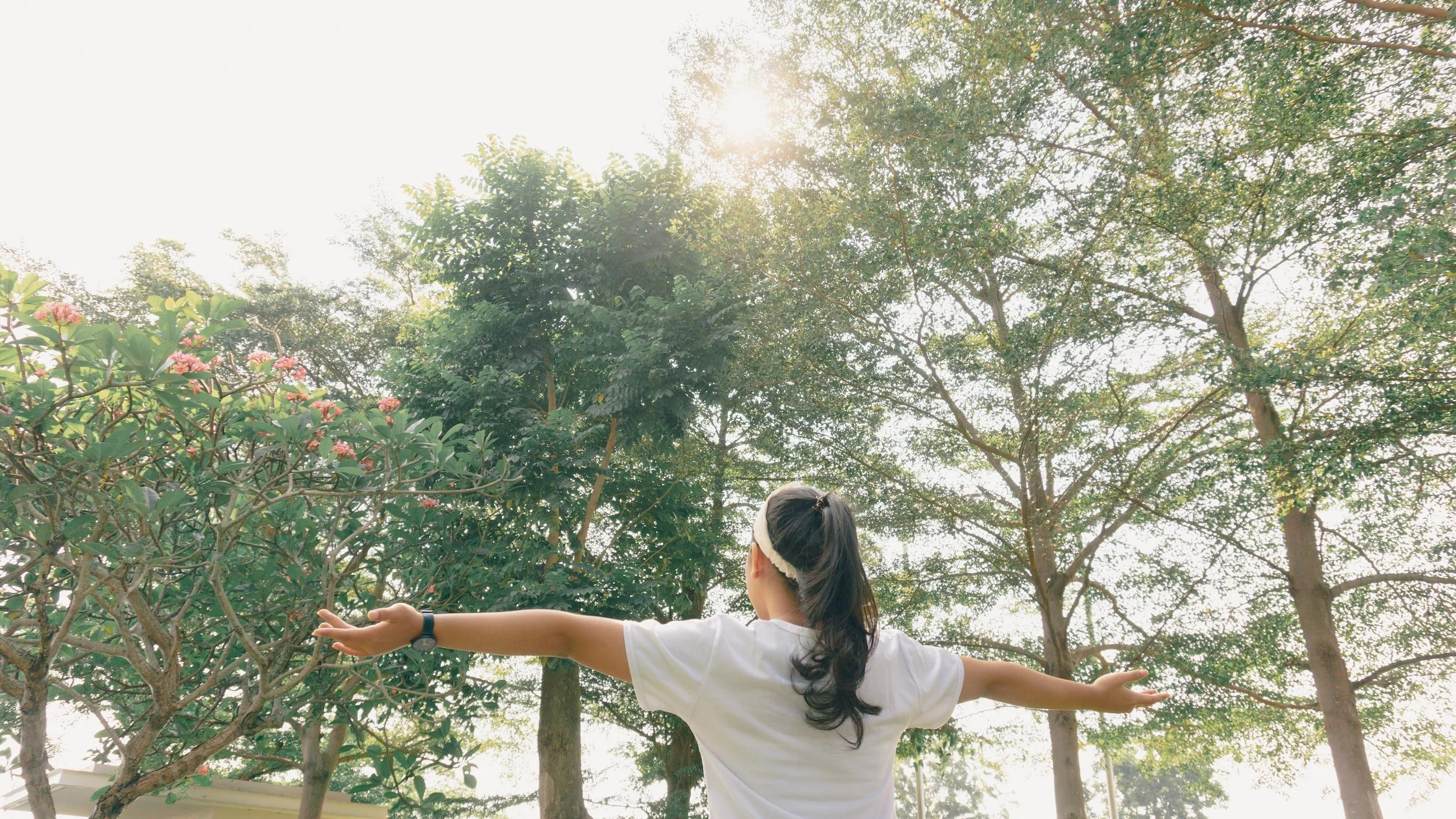 person breathing fresh air in forest
