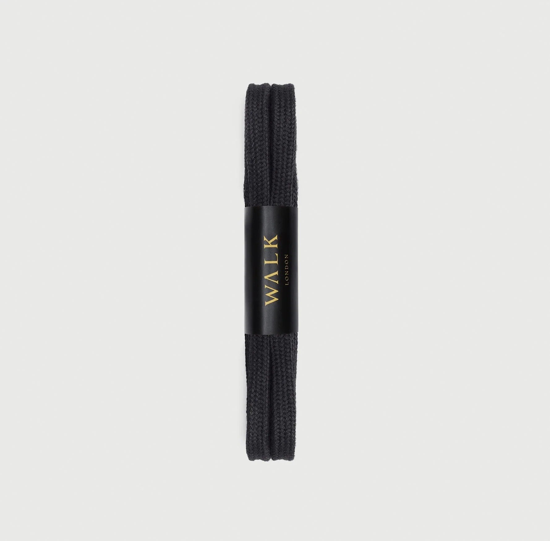 Black WALK London shoelaces with black and gold branded packaging