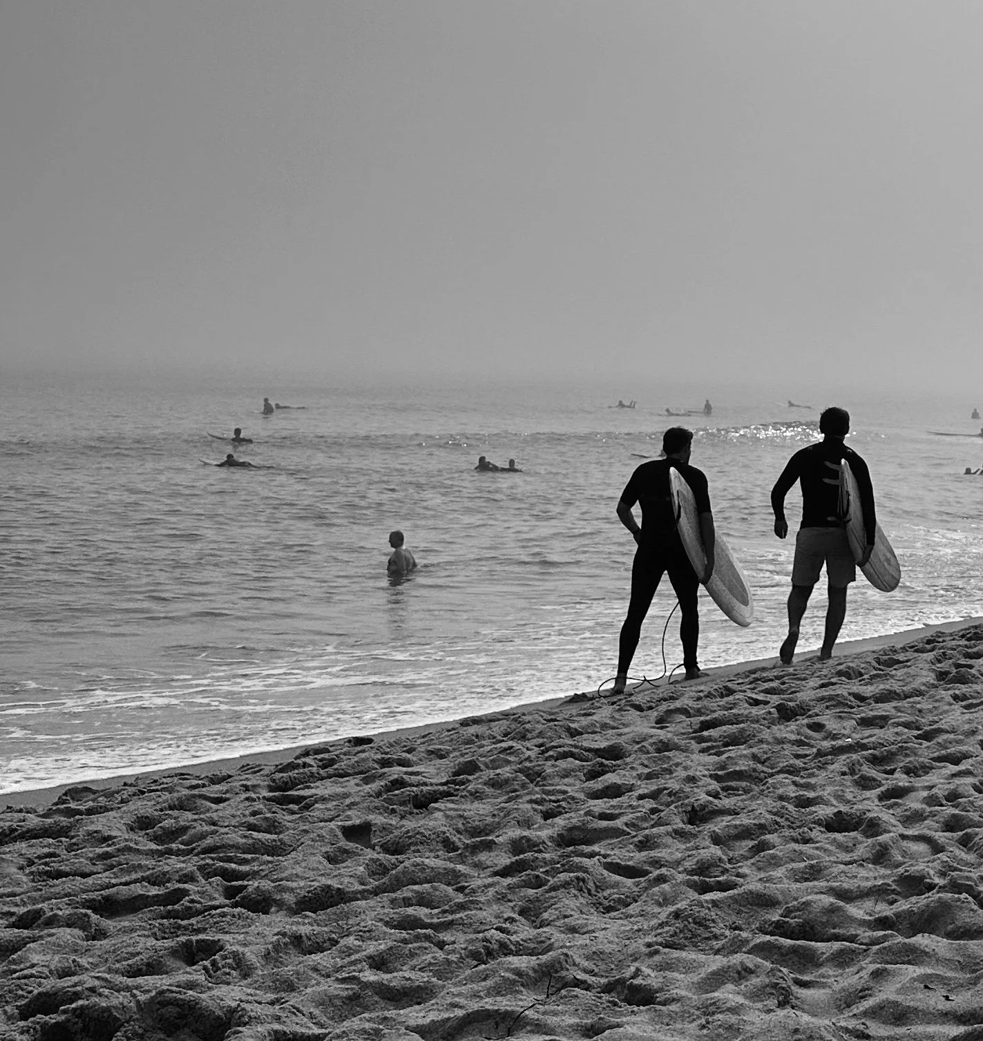 surfers on the beach black and white Youth Prevention Mentors