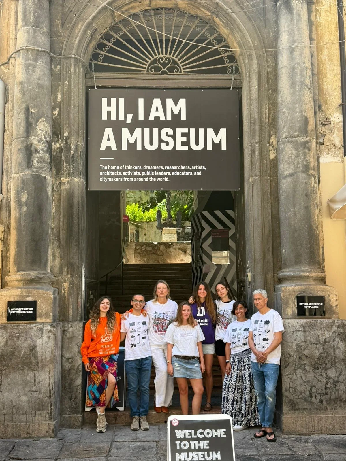 Museum staff welcoming visitors at the entrance to the Museum of the Cities of the World on Via Maqueda in Palermo.