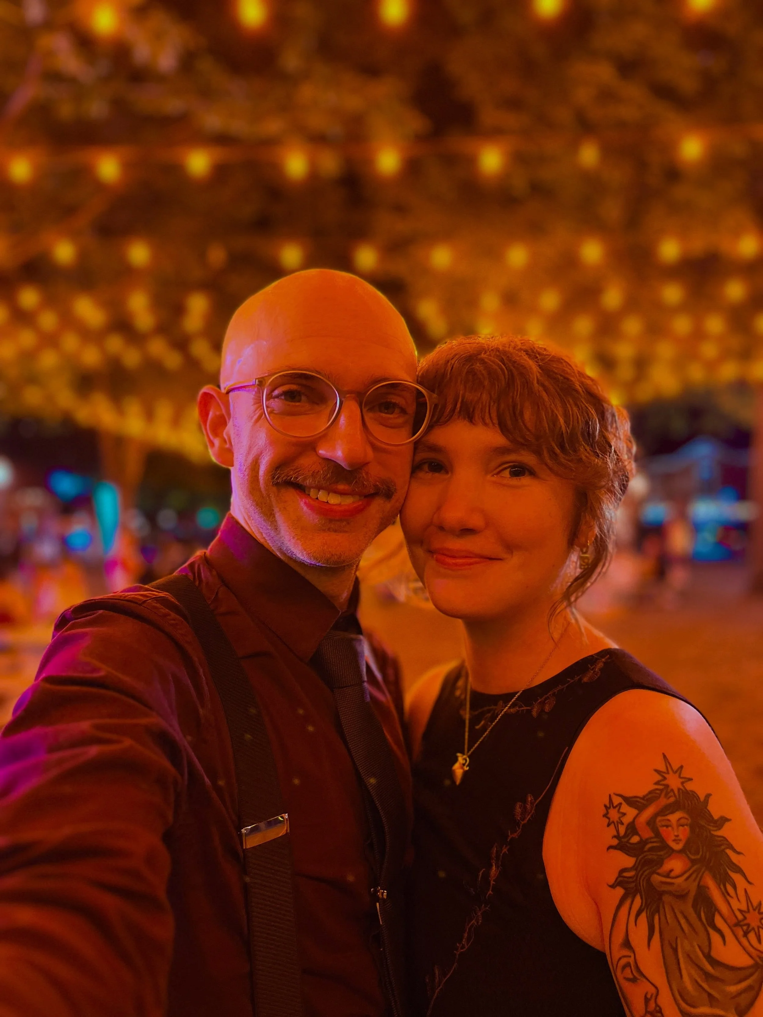 Annual orange lights selfie 🧡✨ the past few weeks have been a whirlwind for @tylergtwombly and I! It was filled with friends, theater and art, and cats. We celebrated Tyler&rsquo;s 40th birthday and our 5-year wedding anniversary (wedding photo at t
