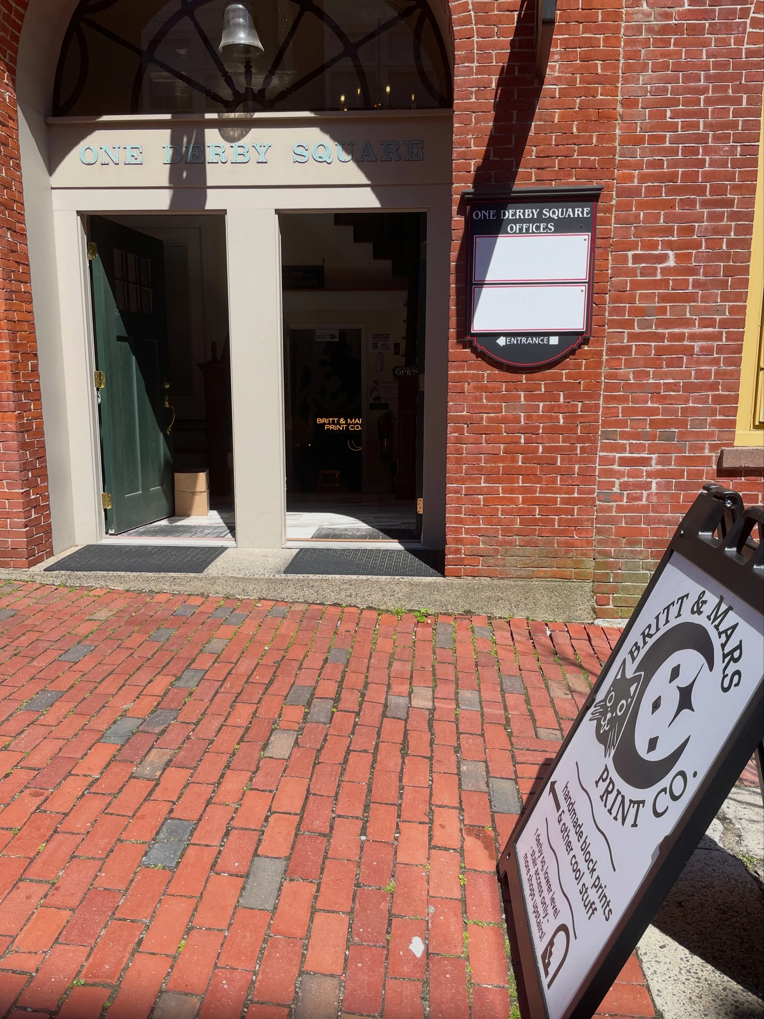 Front door of 1 Derby Sq with the Britt & Mars sign out on the sidewalk