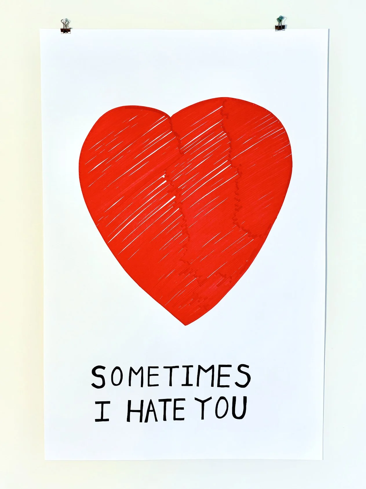 A white poster featuring a large red heart with the text "Sometimes I hate you" written below it.