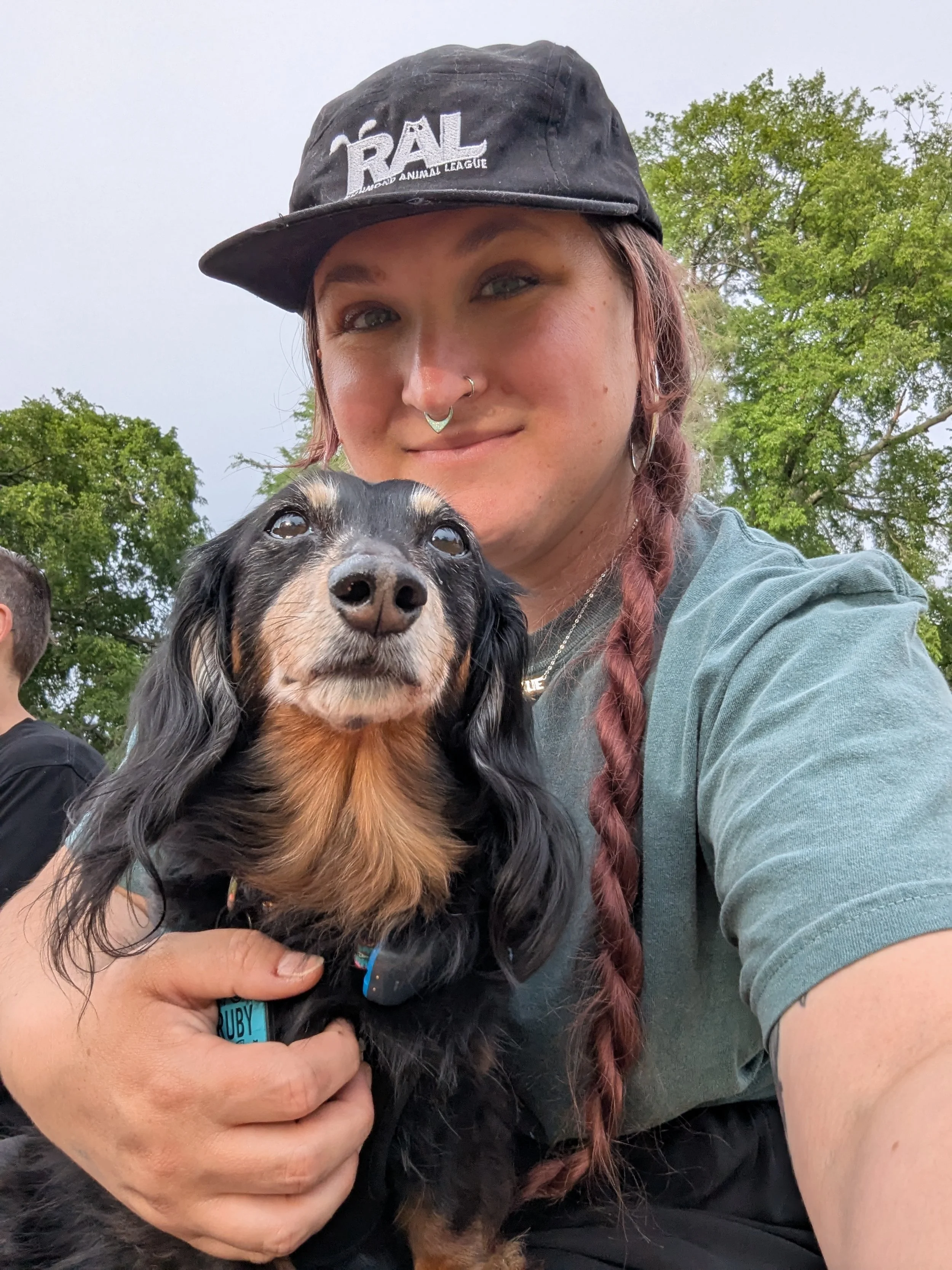 A woman and dog looking into the camera