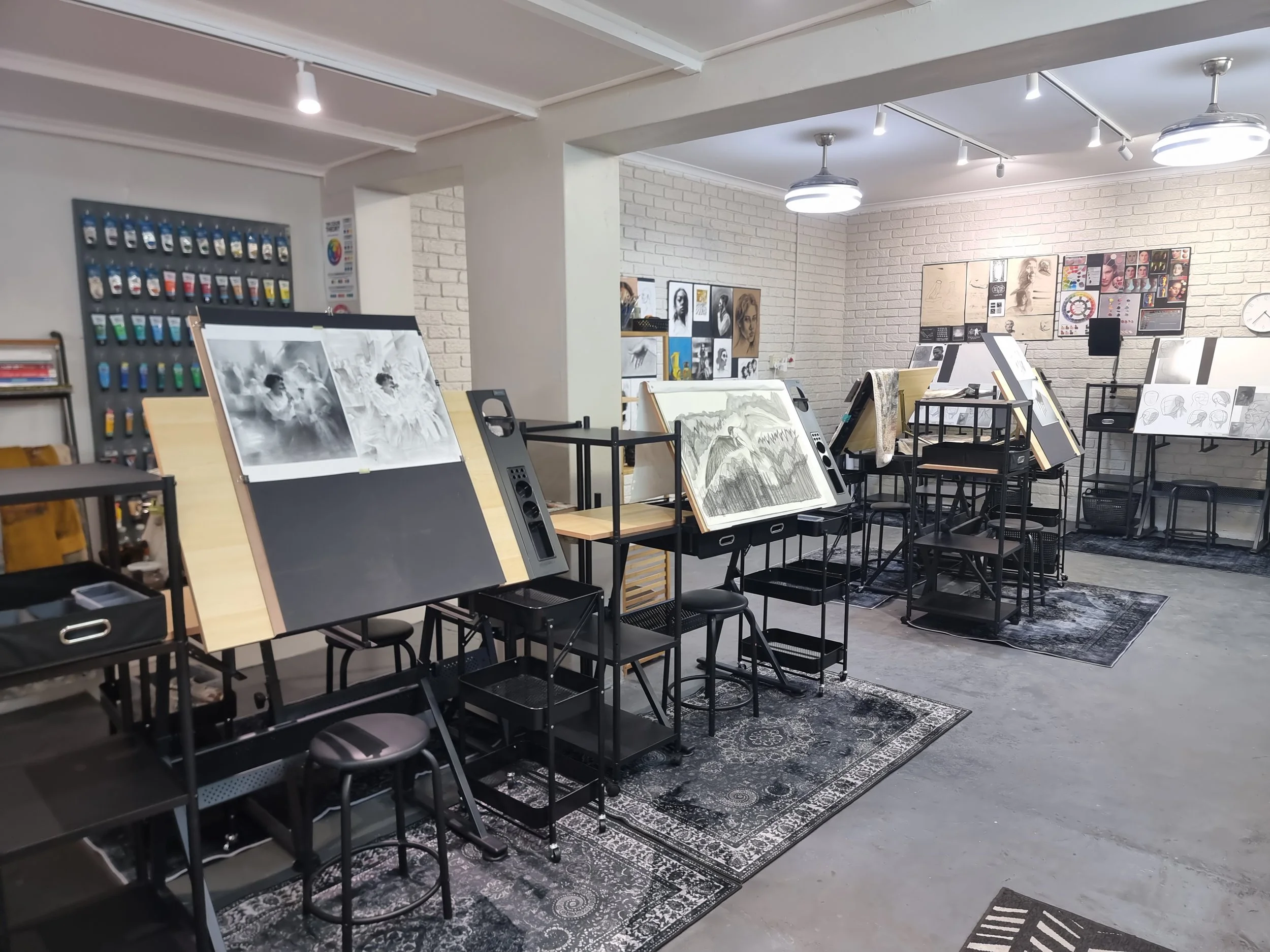 Art studio with drawing tables, chairs, artwork, and supplies. Art studio and art classes in Cape Town, Art classes for adults Durbanville