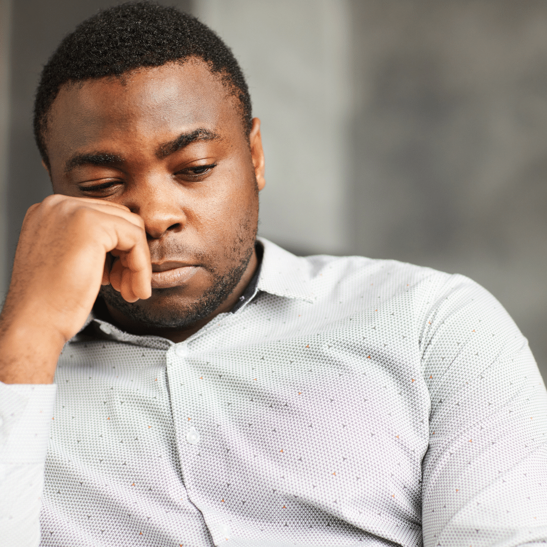 A black man in a deep thought.