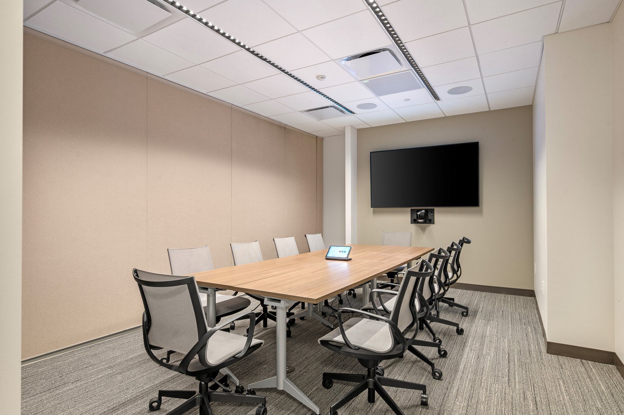 A conference room with a rectangular table, a tv on the far wall, and ten chairs around the table. This is part of Greater Boston Legal Services' space in the North End.