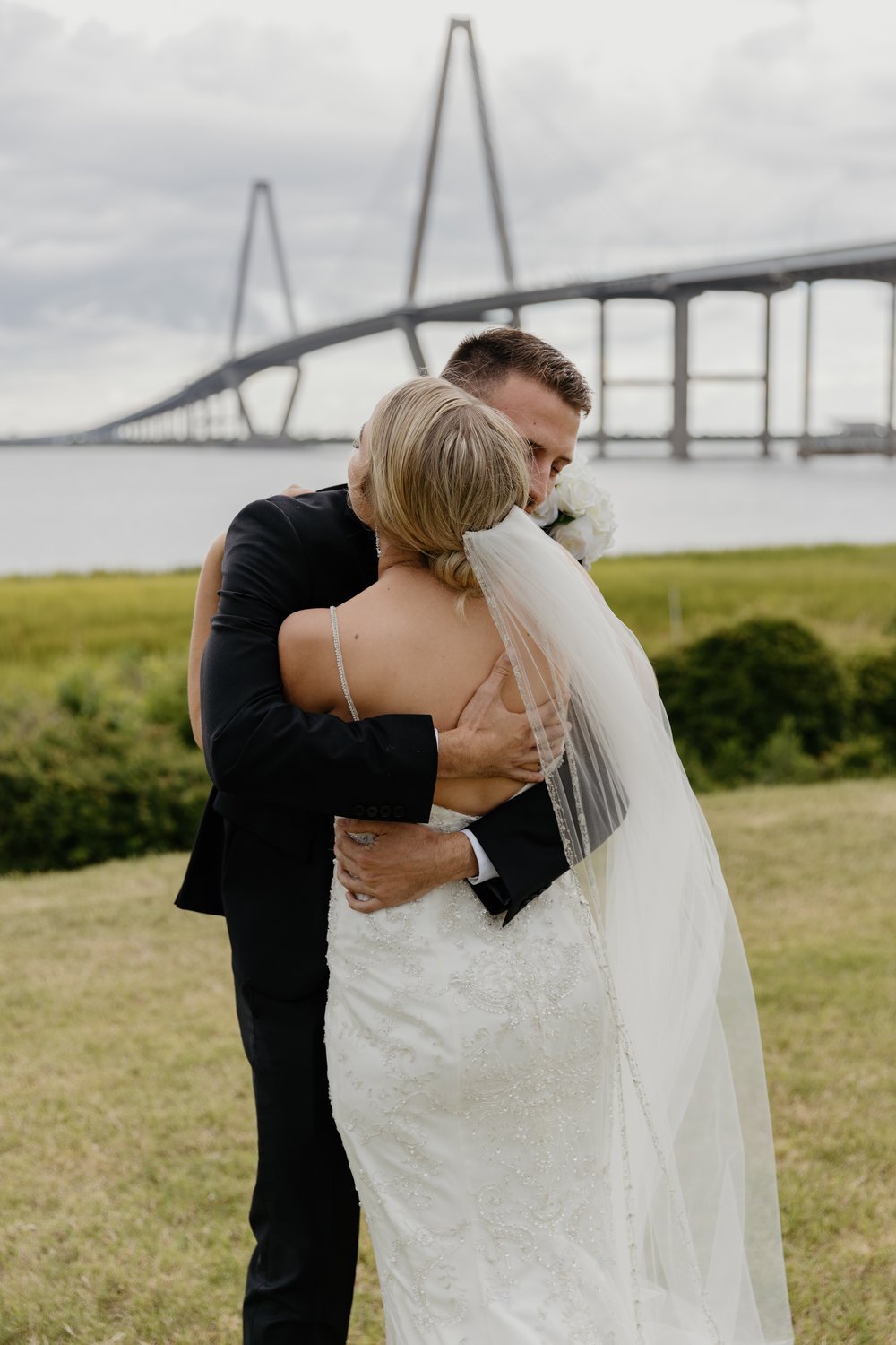 Couple sharing a joyful moment at their first look in Charleston, SC.