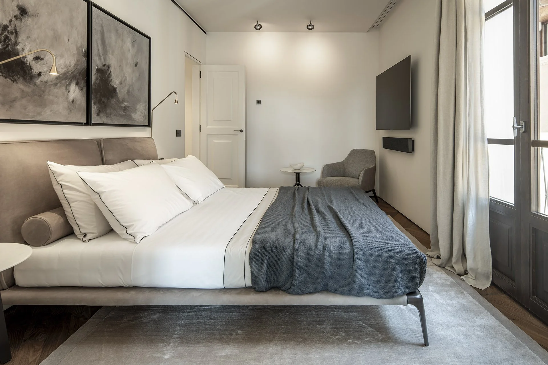 Bedroom with artwork and soft natural light at Villa Calatrava