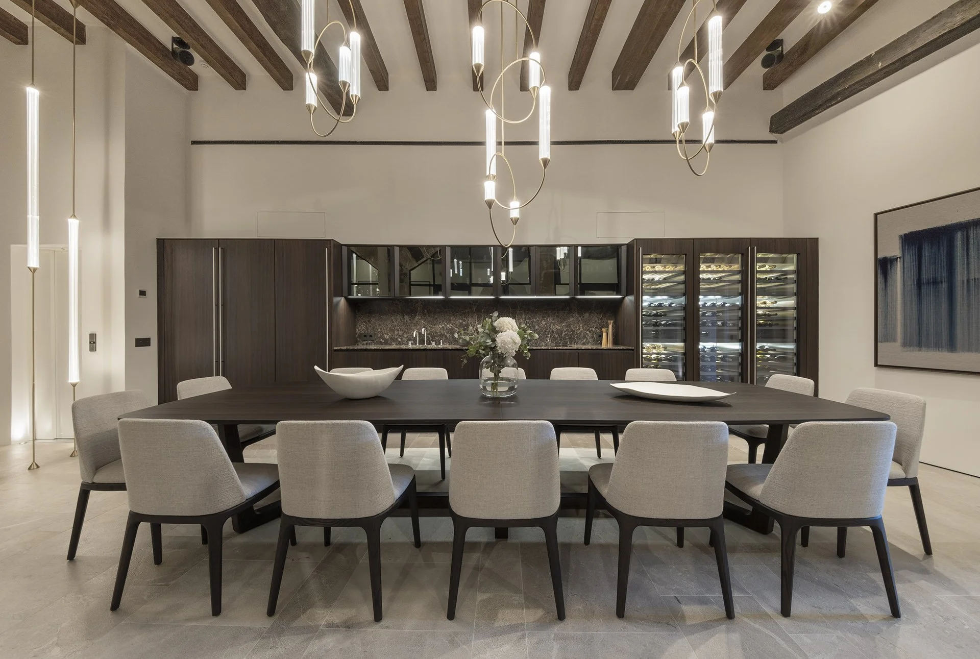 Ground-floor dining table with wine storage and bespoke cabinetry at Villa Calatrava