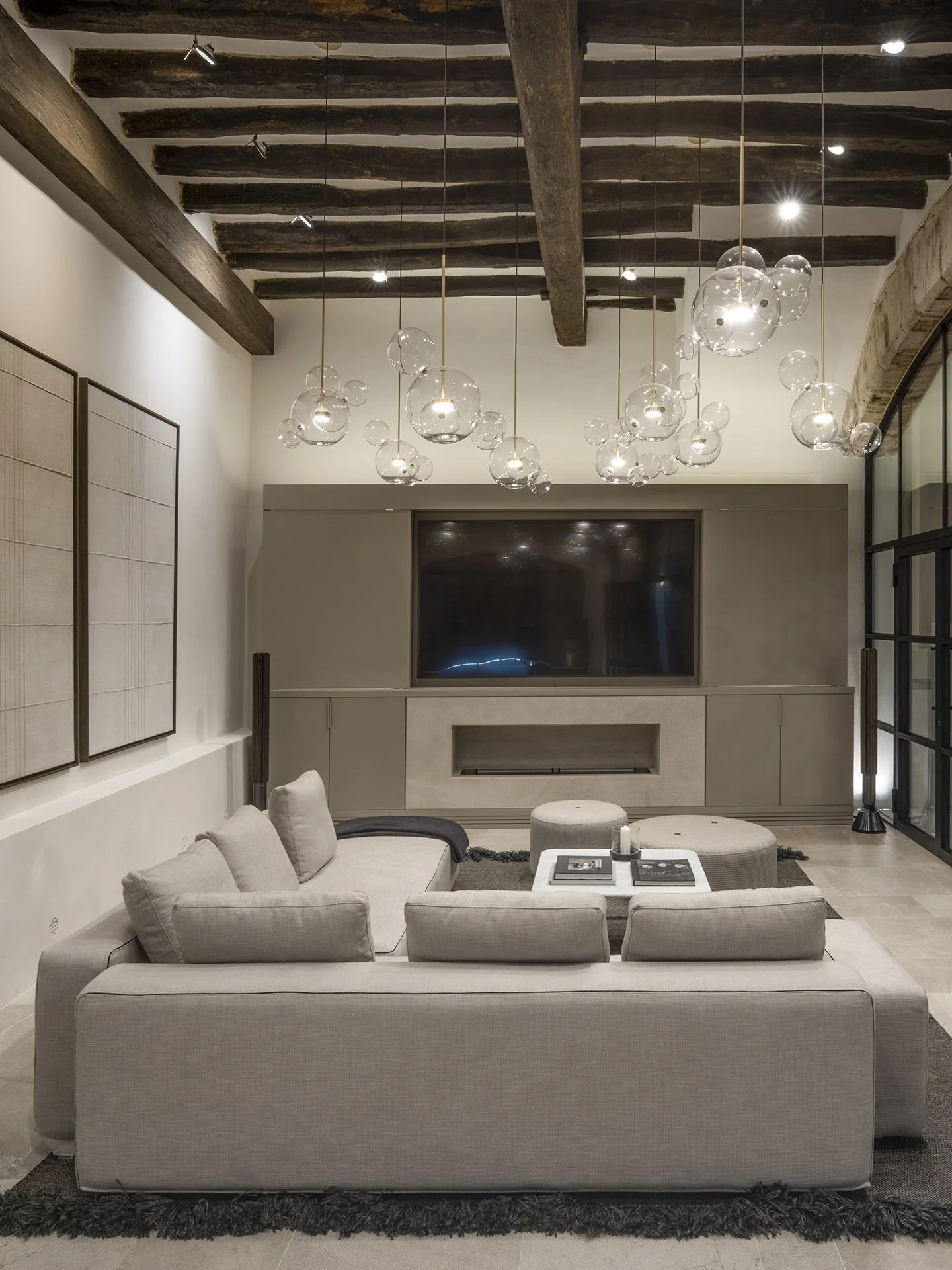 Ground-floor lounge with exposed beams and sculptural lighting at Villa Calatrava