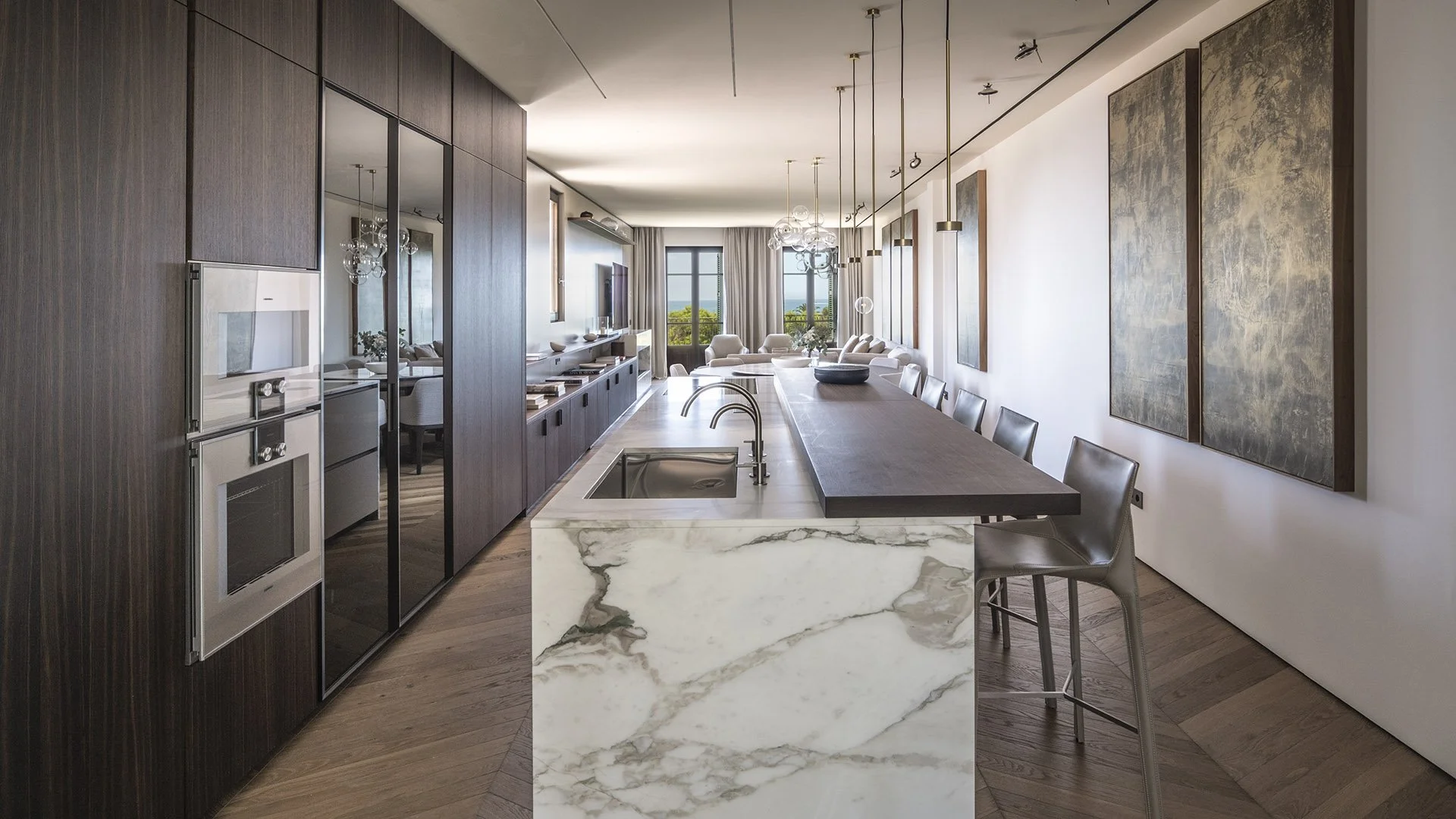 Marble kitchen island looking through the dining and living spaces at Villa Calatrava
