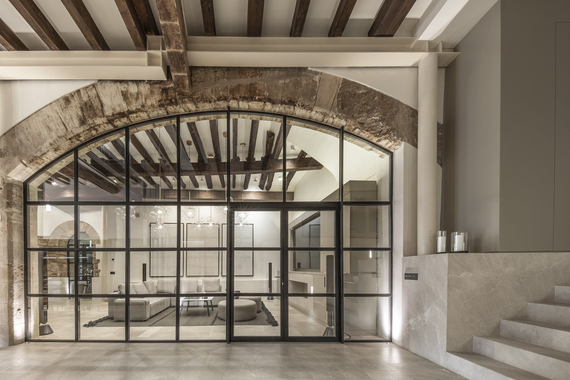 Restored stone arch and glazed partition on the ground floor of Villa Calatrava, Palma Old Town