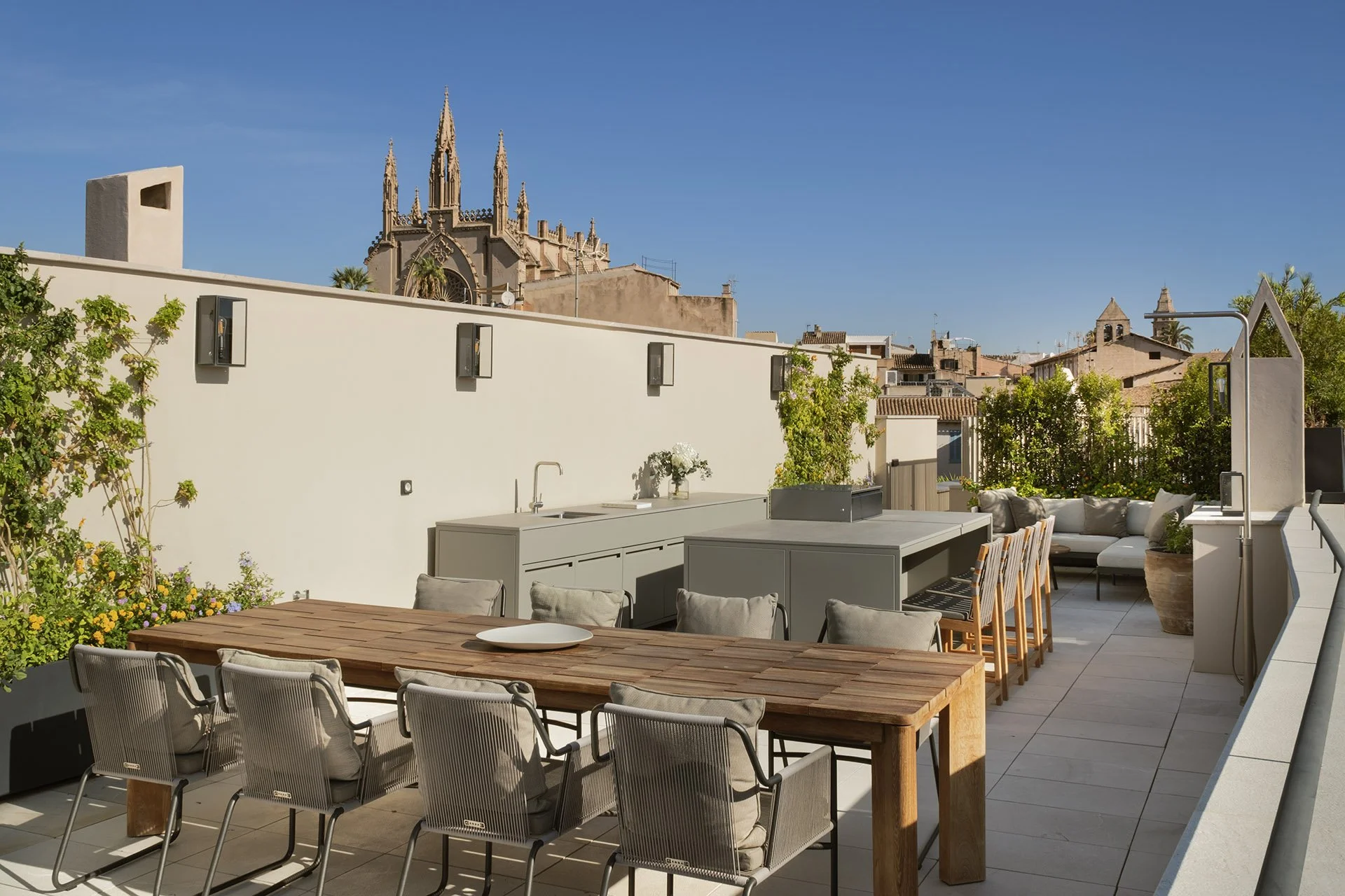 Rooftop dining area and outdoor kitchen with views of Palma Cathedral