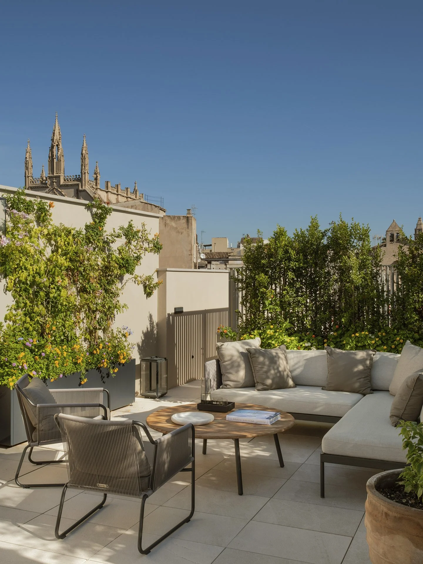 Rooftop lounge seating with views of Palma Cathedral at Villa Calatrava