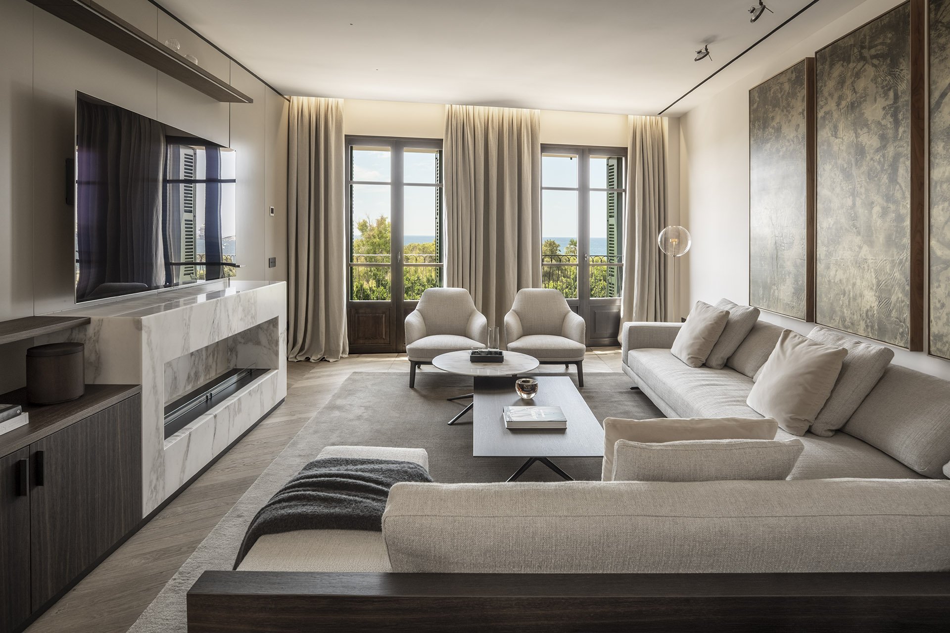 Main lounge with fireplace and sea-facing windows at Villa Calatrava