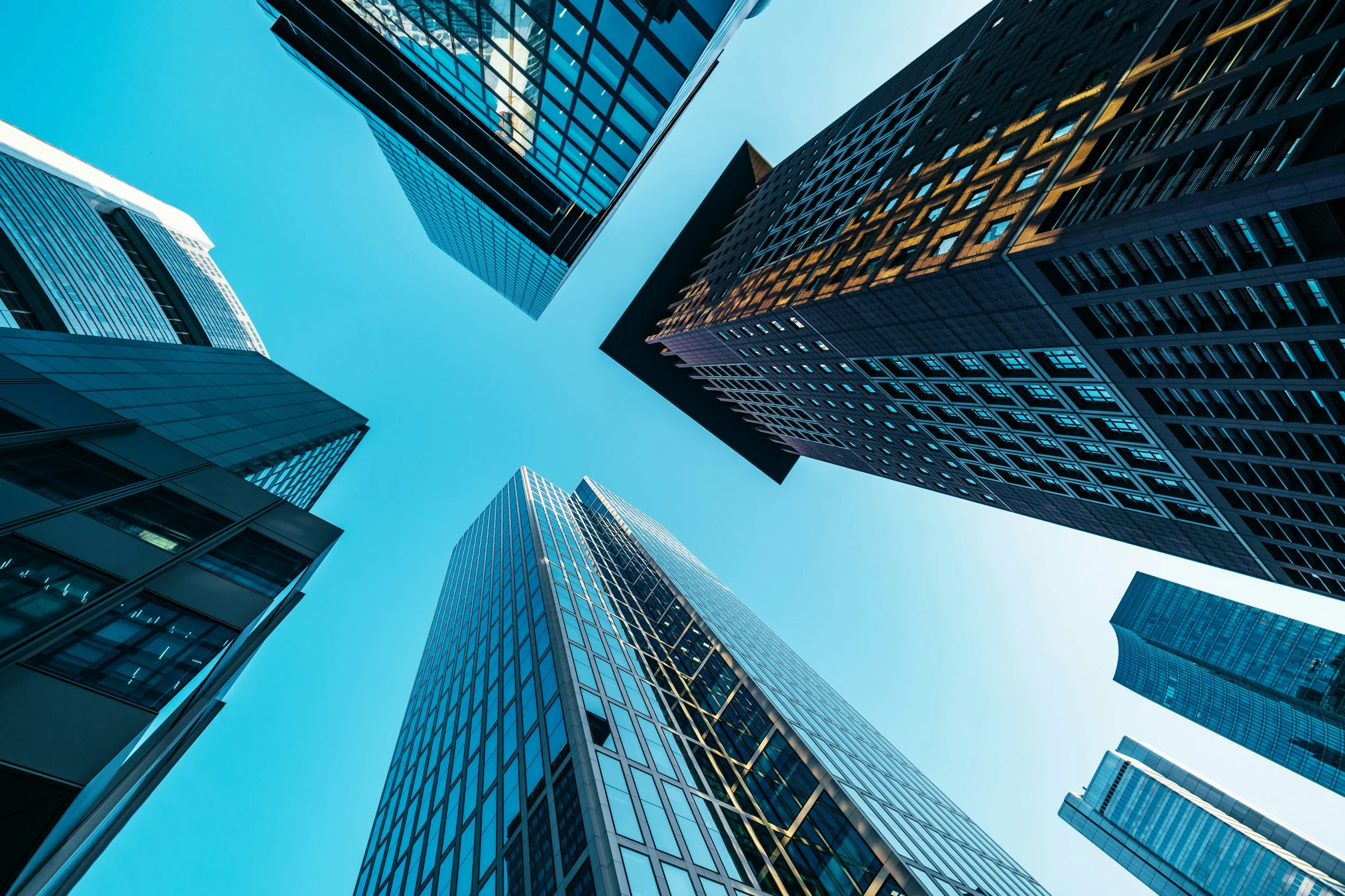 Upward view of modern office buildings in an urban city center.