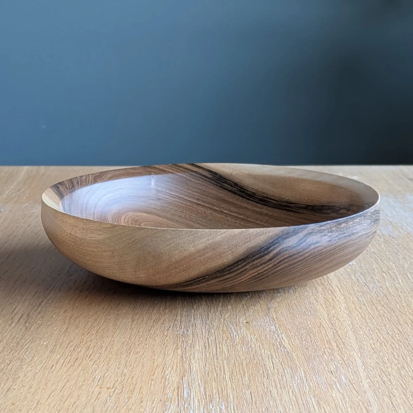 English walnut with grain that shifts from pale caramel to deep chocolate. Wrapping right through the rim. Turned to a clean, balanced form that&rsquo;s practical without feeling heavy or overbuilt.

The proportions are simple - 25cm across, 6cm high